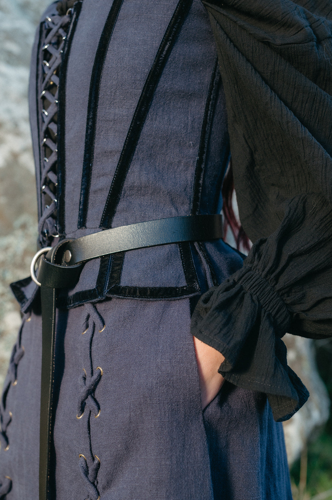 Close-up of a person wearing a tavern skirt with detailed stitching and a black belt around the waist