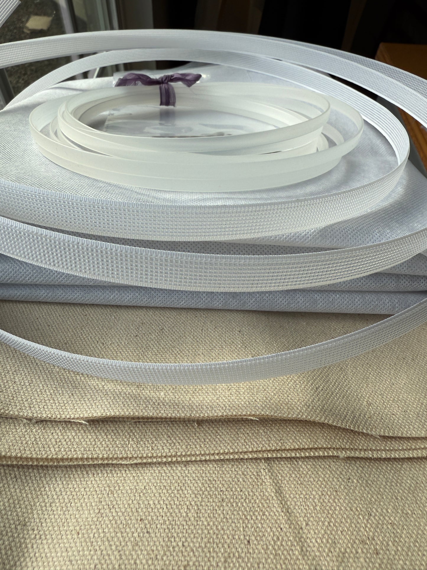 Corset Making Materials Kit showing fabric, plastic boning, rigilene, and interfacing neatly arranged for sewing project.