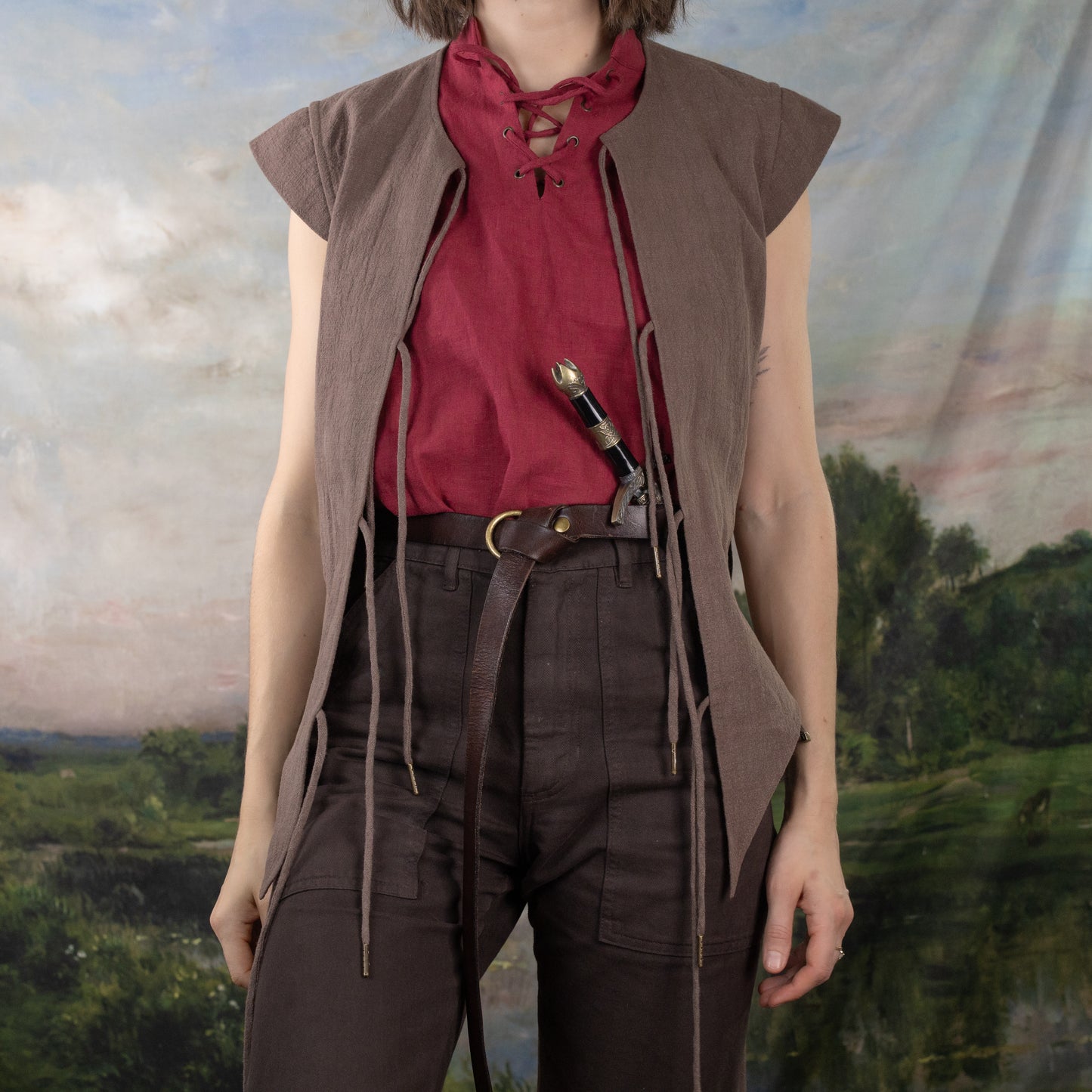 Brown Bard Vest with adjustable front ties worn over burgundy shirt, paired with dark pants in renaissance style setting