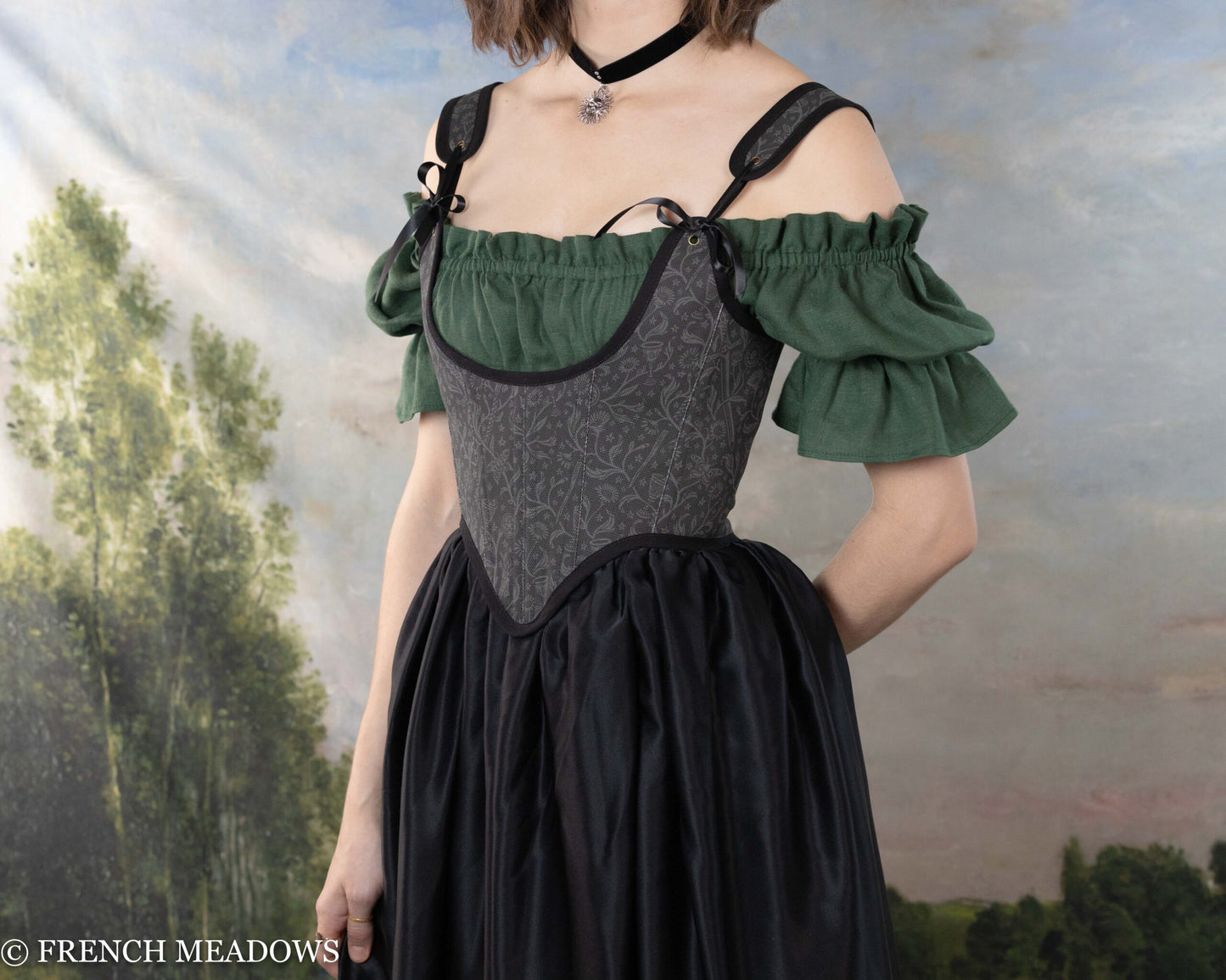 Black Tarot Underbust Bodice with ruffled green sleeves and black skirt, worn over shoulder dress with renaissance-inspired design