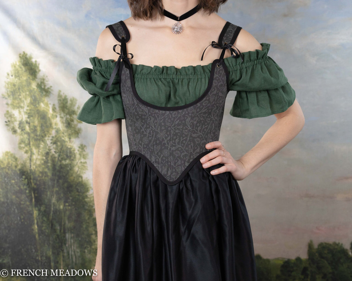 Black Tarot Underbust Bodice worn with green peasant blouse, showcasing dark brocade pattern and adjustable shoulder straps