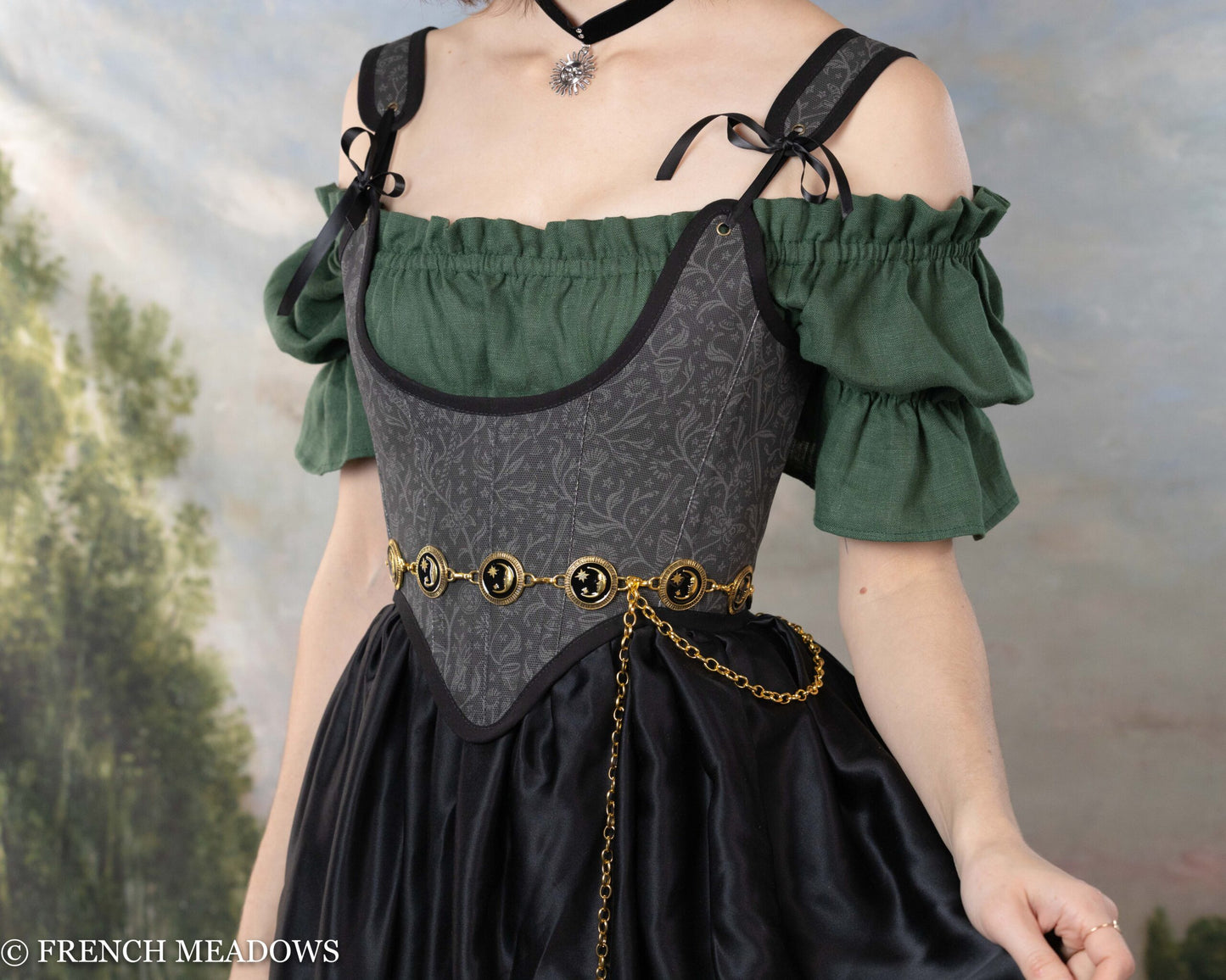 Black Tarot Underbust Bodice paired with green peasant top, featuring mystical pattern and decorative chain belt
