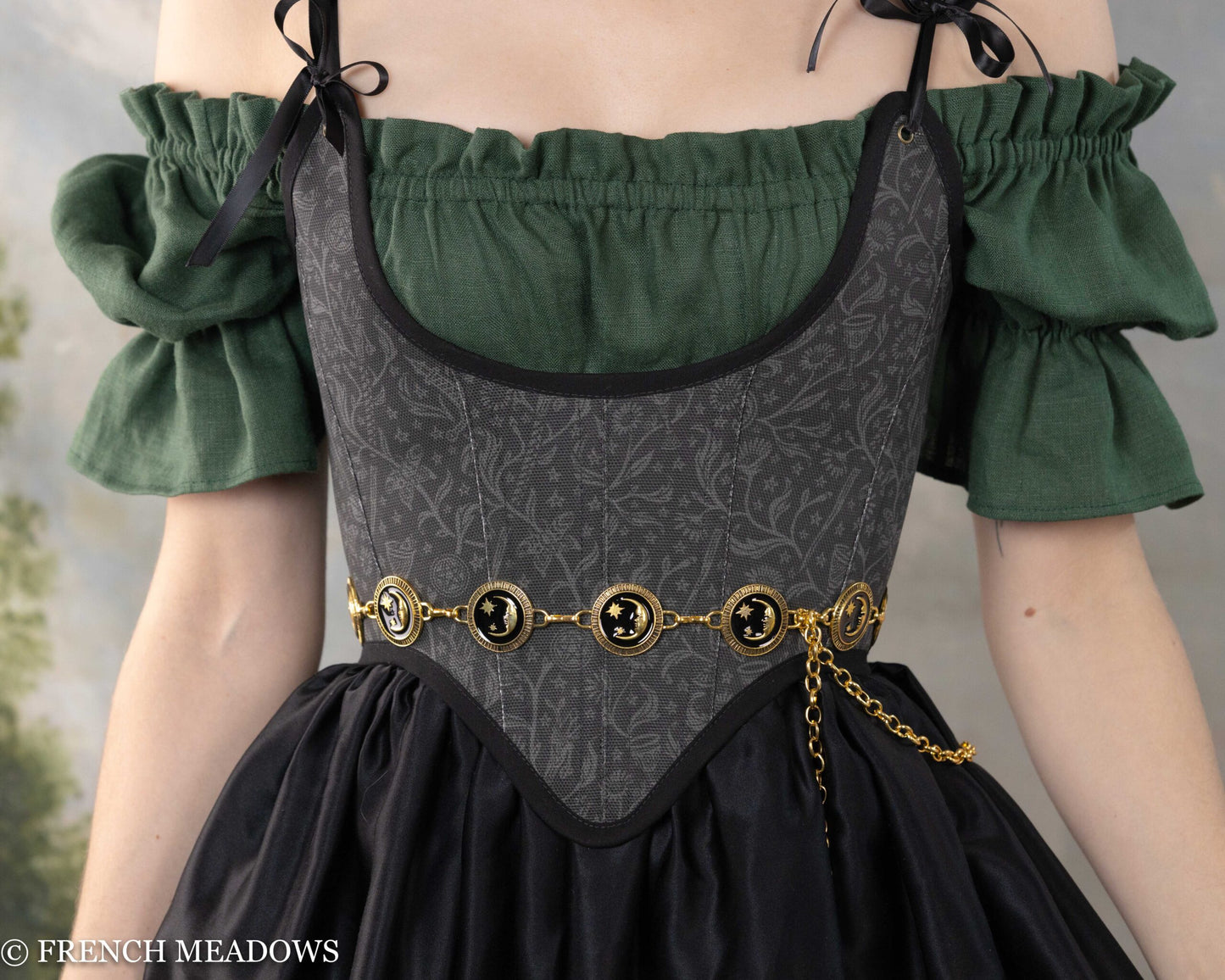 Black Tarot Underbust Bodice with ornate gold chain belt, paired with green puff-sleeve blouse and full black skirt