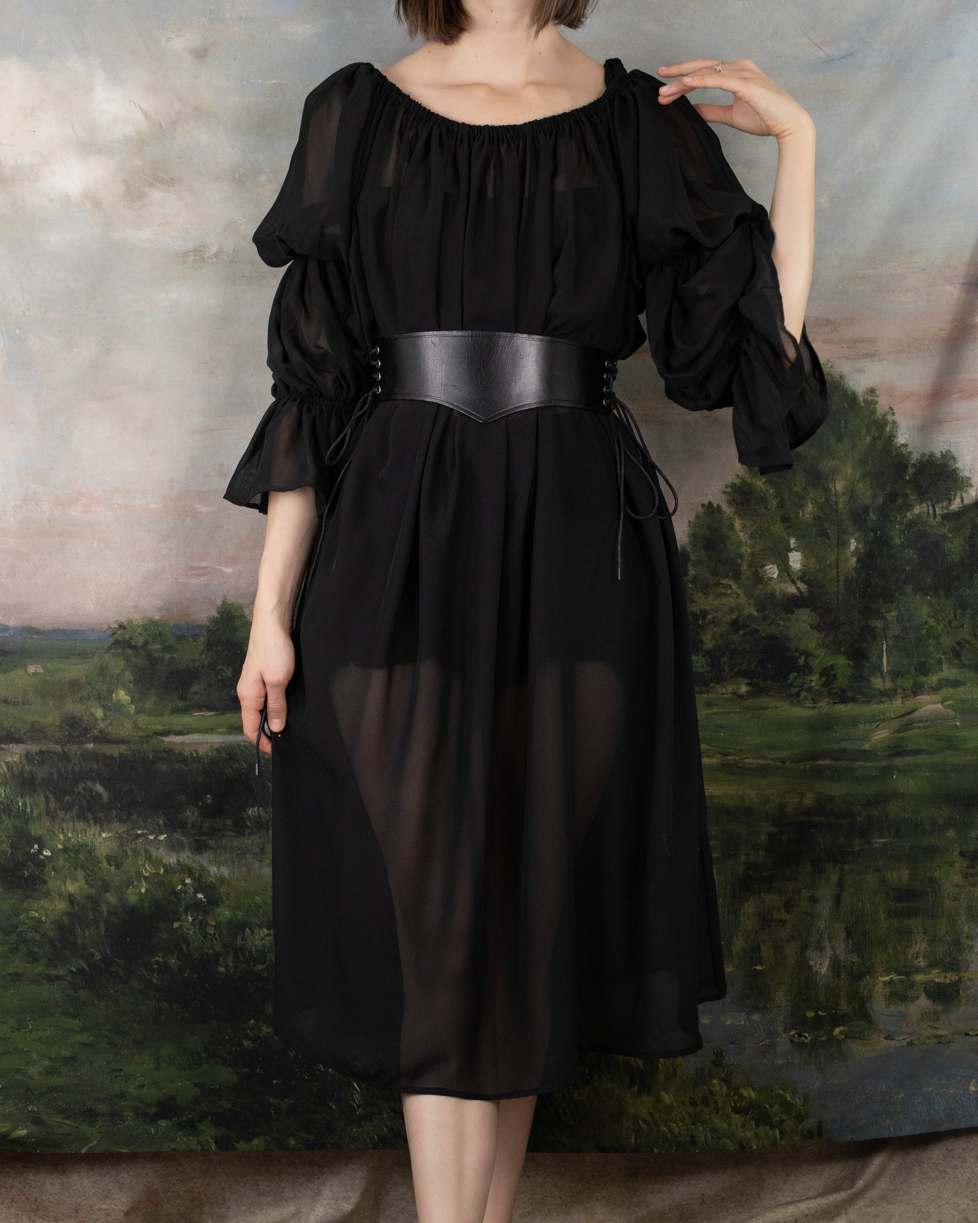 Black Chiffon Long Sleeve Chemise with puff sleeves and wide leather belt shown against pastoral landscape backdrop