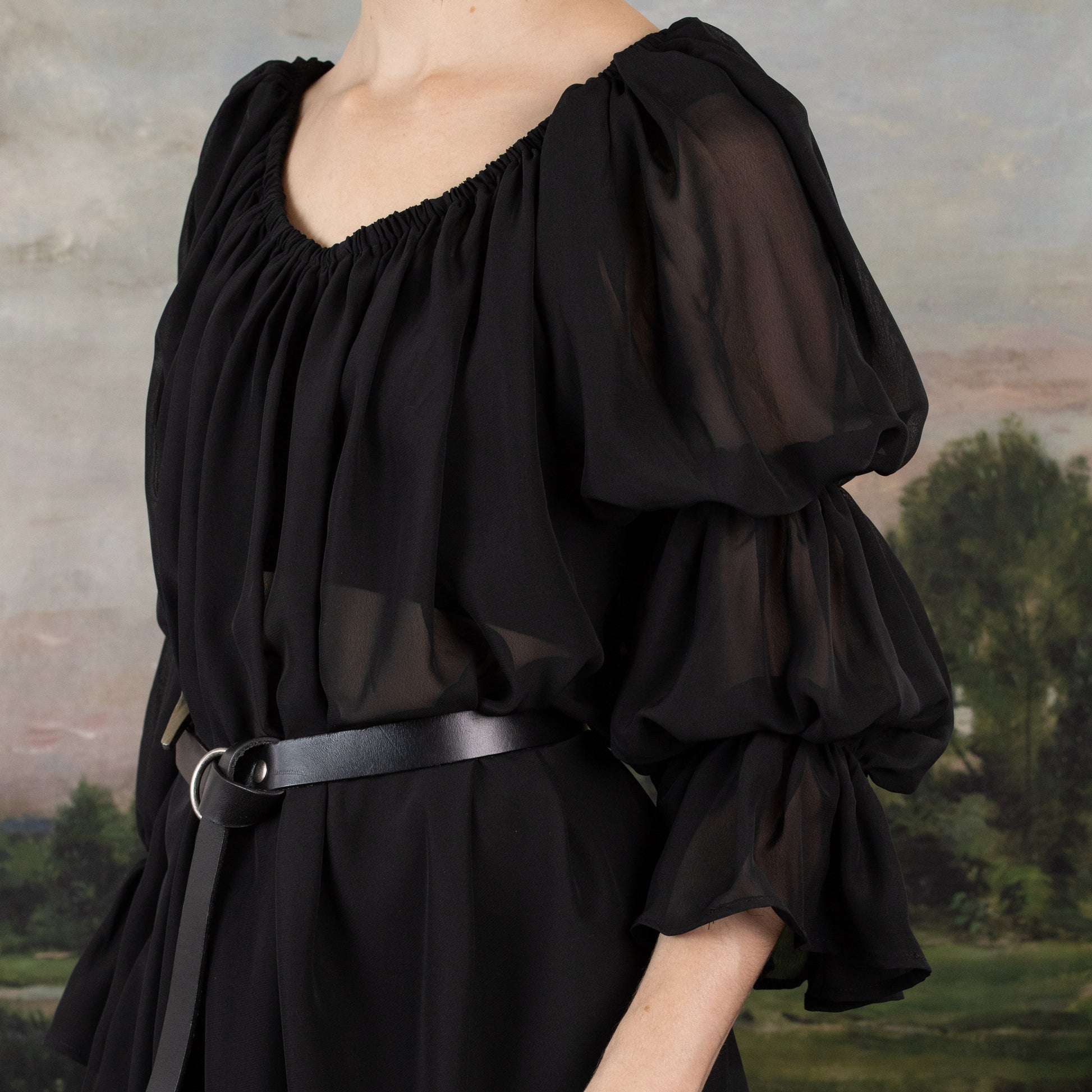 Black Chiffon Long Sleeve Chemise with puff sleeves and elastic ruched neckline, styled with black belt against pastoral backdrop