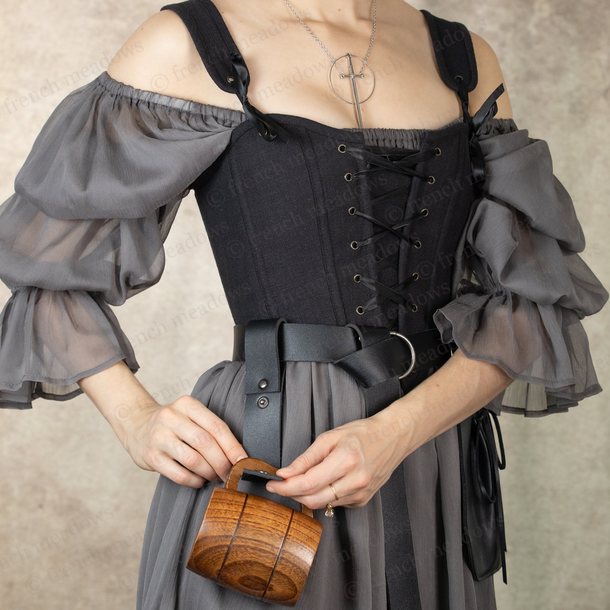 Vegan leather tankard strap attached to medieval costume belt with wooden mug demonstrating strap functionality