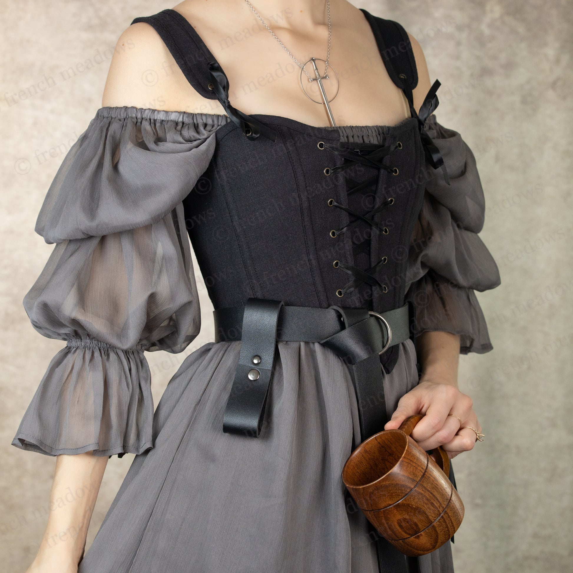 Vegan leather tankard strap shown with medieval dress and wooden mug for renaissance faire and LARP costumes