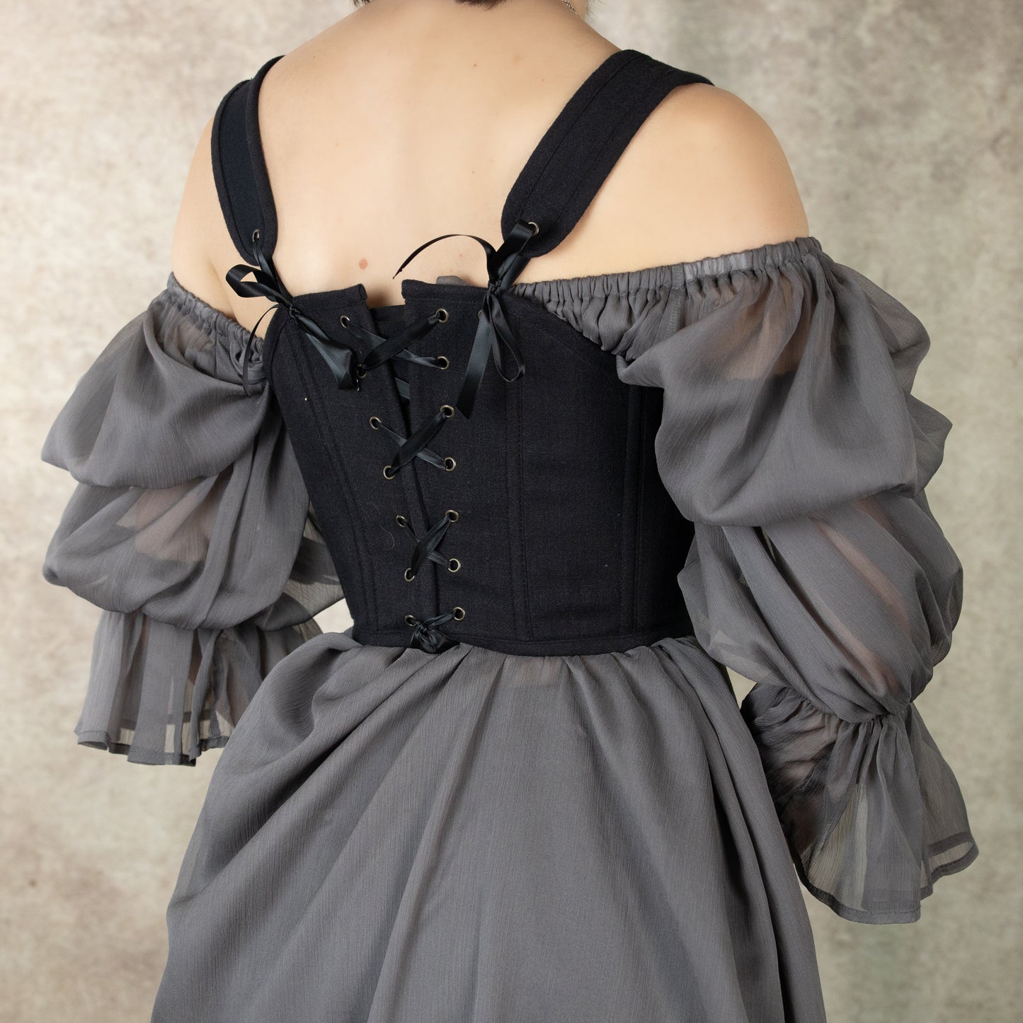 Black Cotton Corset Top with off-shoulder grey puffy sleeves and back lacing detail, shown from behind