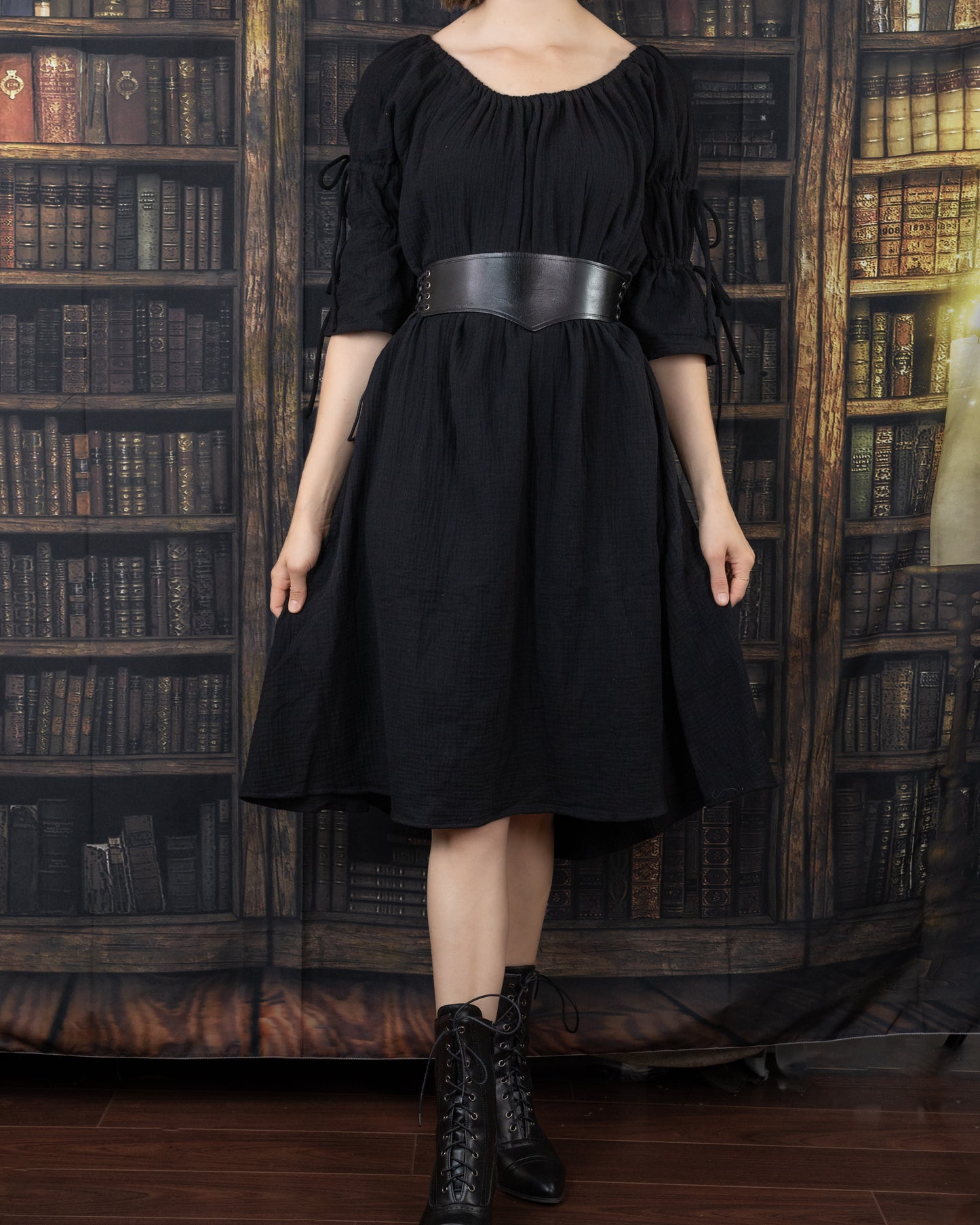 Wide Leather Waist Belt shown on black medieval dress against library backdrop, displaying adjustable side lacing detail