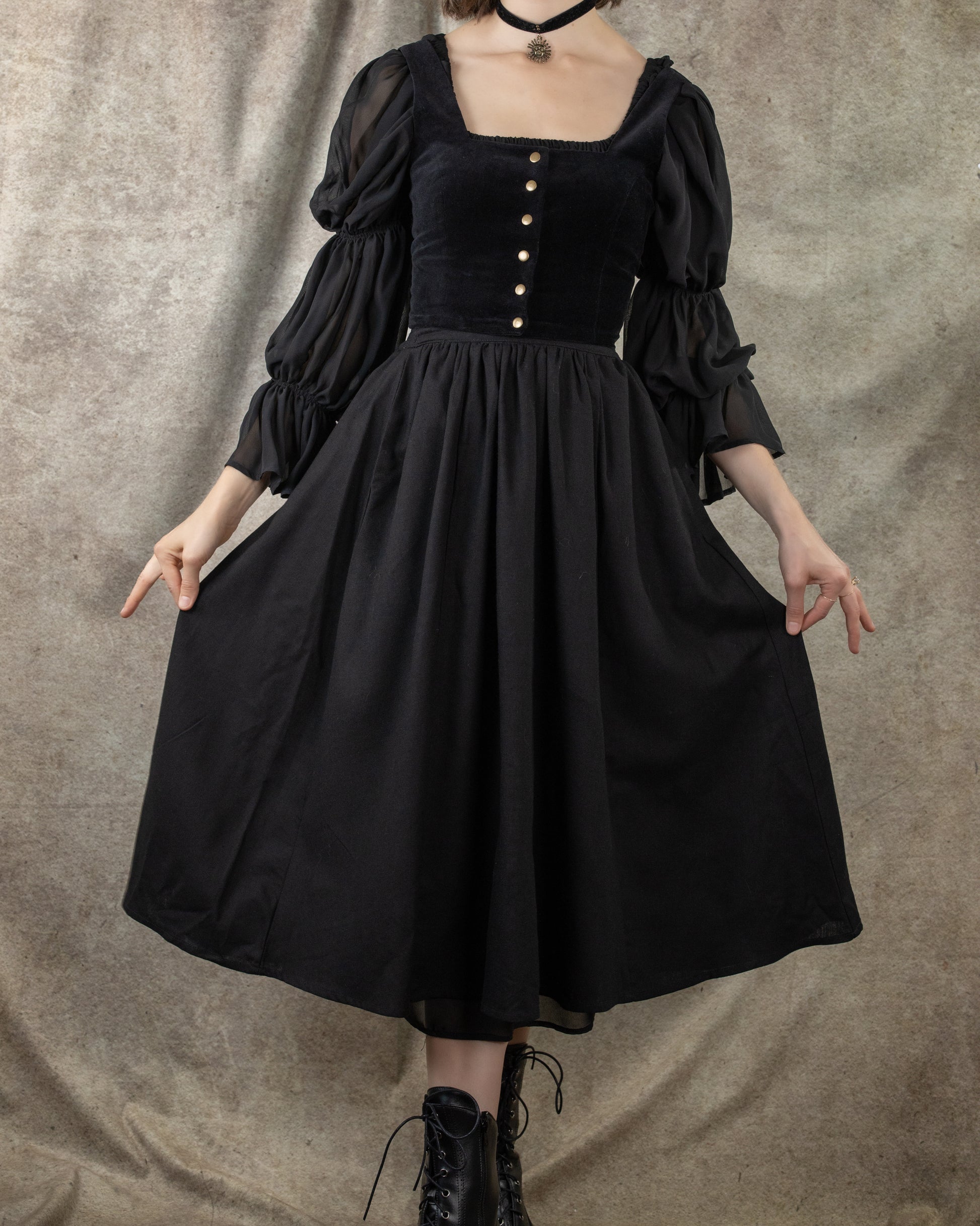 Black cotton midi skirt with gathered waist, hidden pockets and full skirt shown with vintage-inspired dress styling