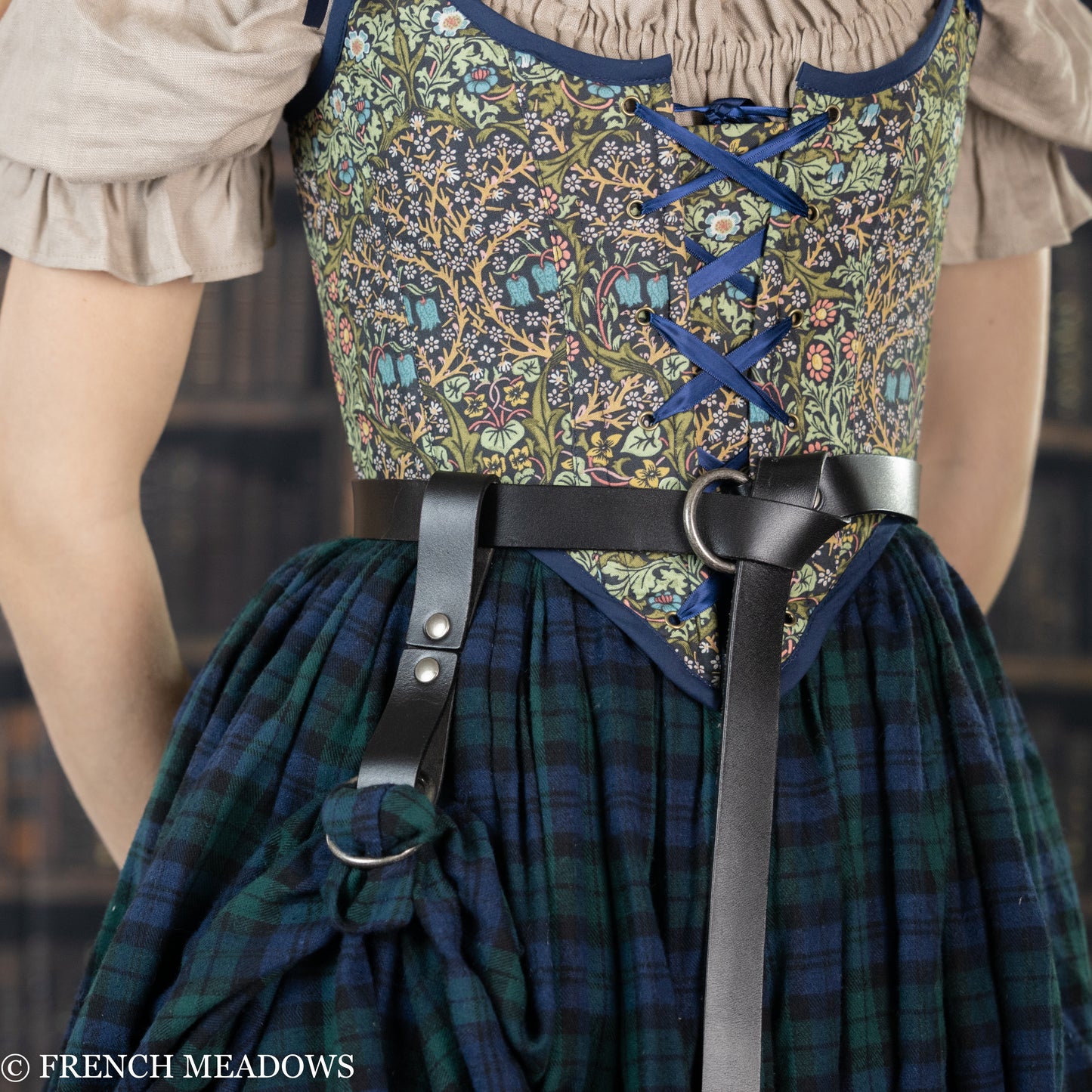 Leather Skirt Hikes shown on plaid renaissance dress with floral bodice and black leather belt, demonstrating wear method