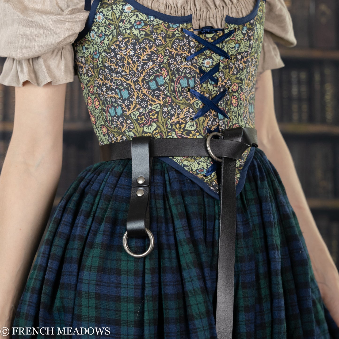 Leather Skirt Hikes shown on plaid renaissance dress with floral bodice and O-ring attachments for lifting skirt layers