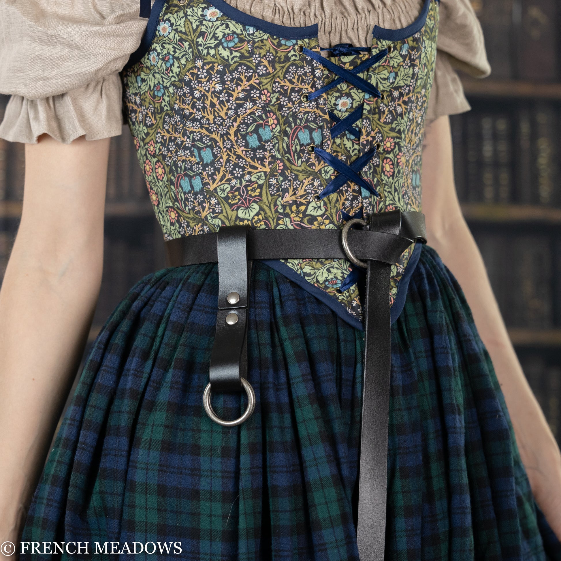 Leather Skirt Hikes shown on plaid renaissance dress with floral bodice and O-ring attachments for lifting skirt layers