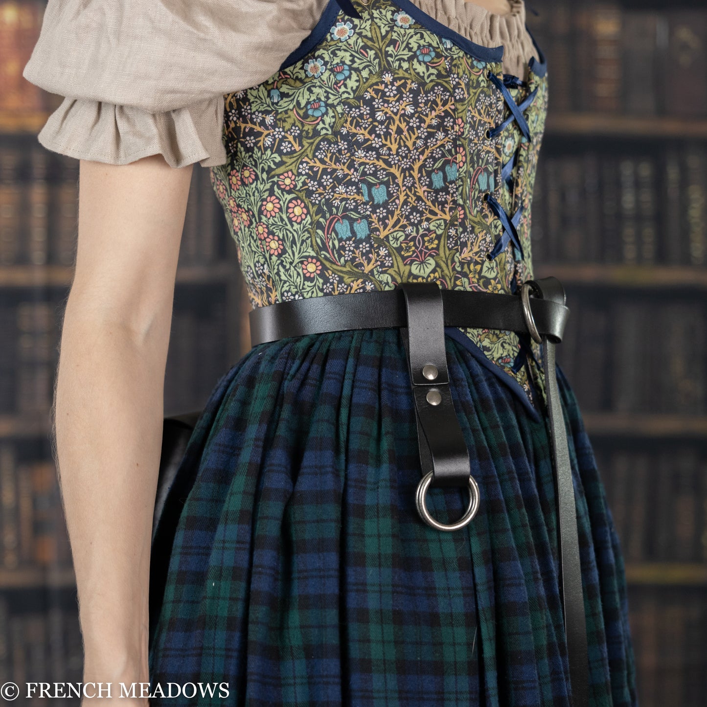 Leather Skirt Hikes shown on plaid renaissance dress with floral bodice, demonstrating attachment to black leather belt