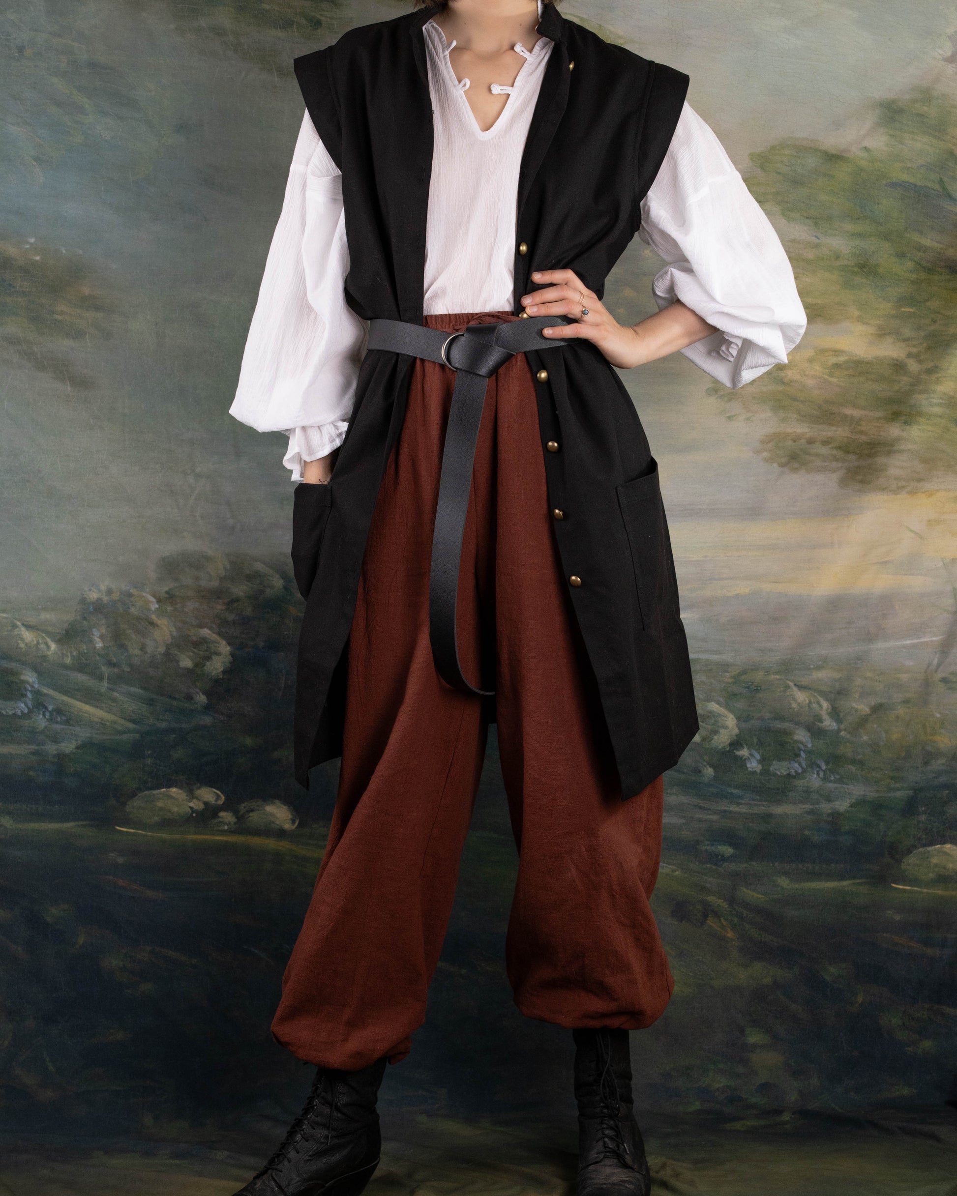 Black Pirate Vest in black linen over white shirt and brown pants with leather belt, styled for renaissance or pirate costume.