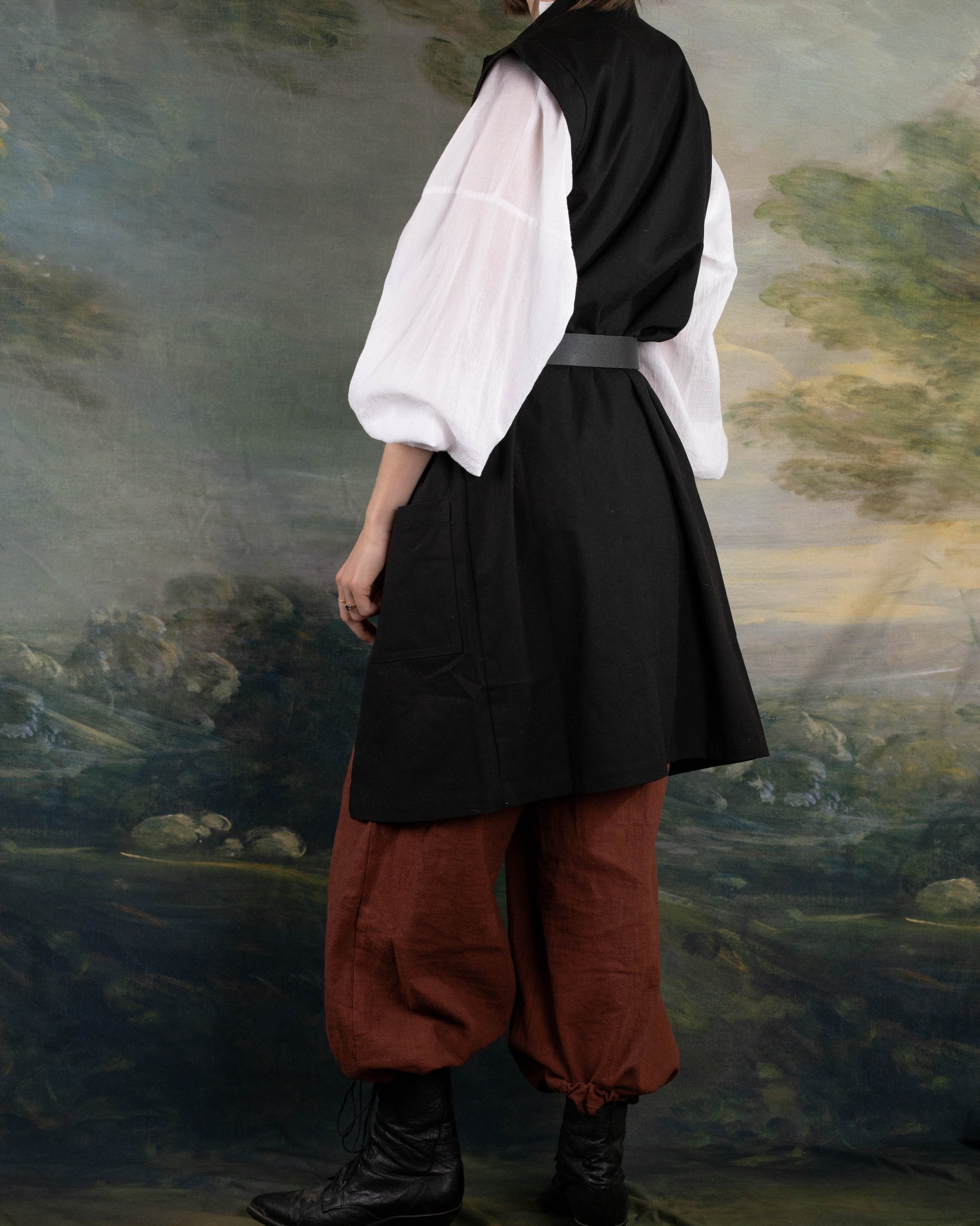 Black Pirate Vest in rich linen, styled over white shirt and brown pants for a historical renaissance look.