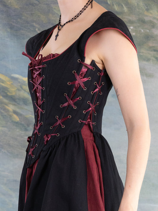 Black Vampire Slayer Corset Dress with adjustable structured bodice and lace-up details in matte black and deep red accents