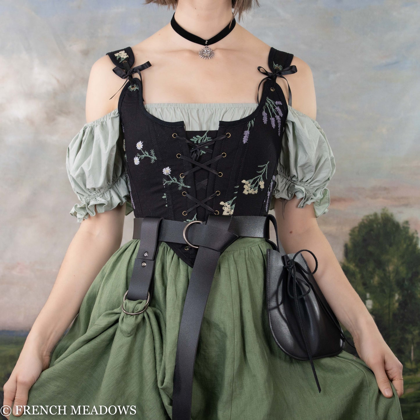 Black vegan leather Renaissance belt worn with medieval-style dress featuring sage green skirt and floral corset