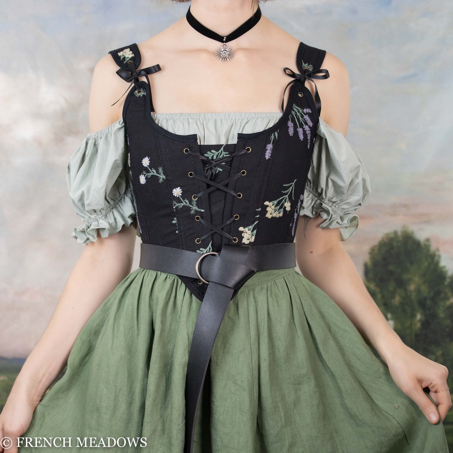 Vegan leather renaissance belt shown on medieval dress with black corset and green skirt, styled for cosplay costumes.