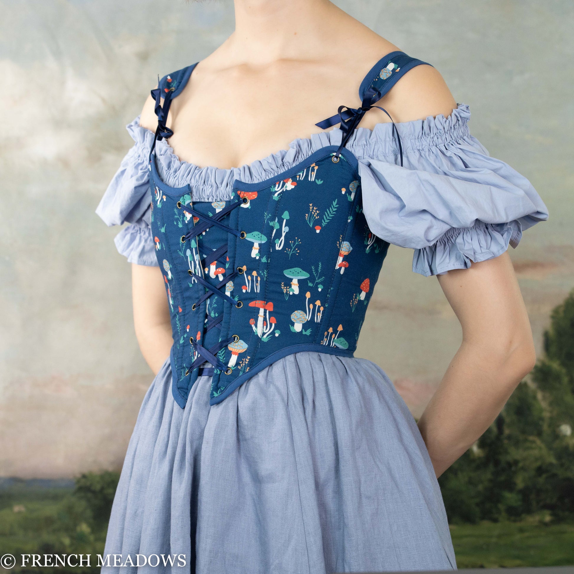 Blue Mushroom Renaissance Bodice with whimsical mushroom print, puff sleeves and front lacing details on light blue dress