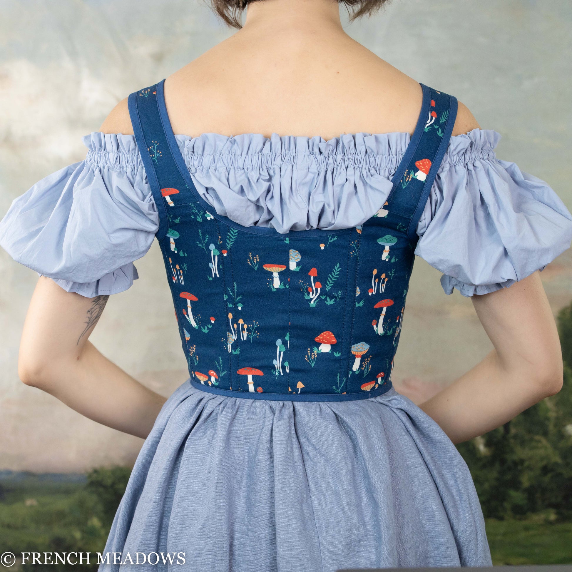 Blue Mushroom Renaissance Bodice featuring off-shoulder sleeves and navy corset with whimsical mushroom print pattern and lace-up front