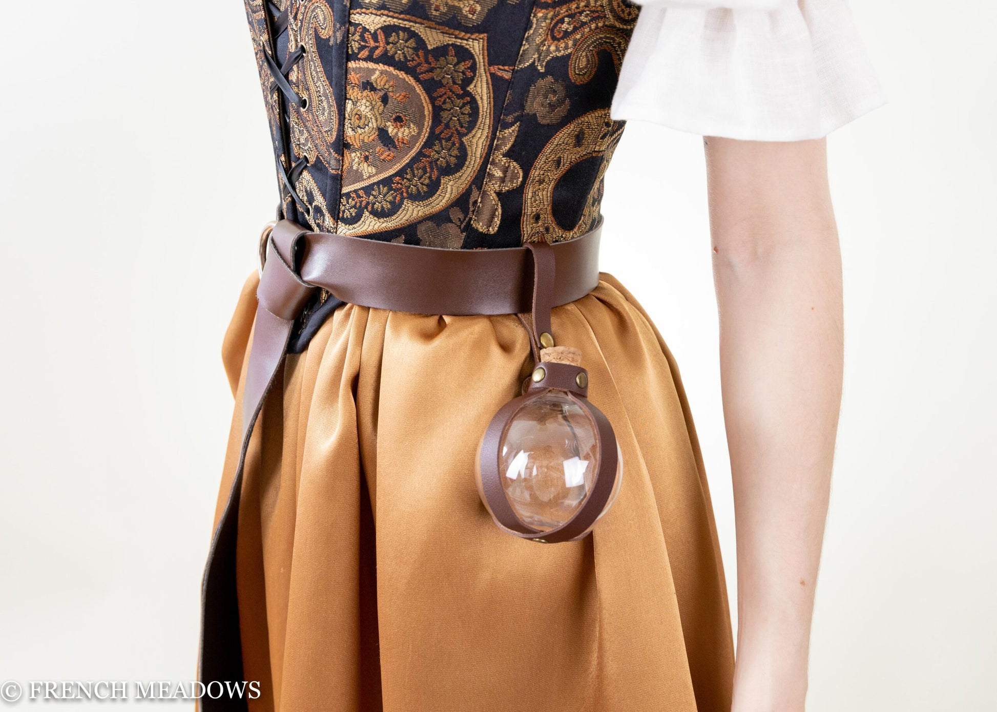Potion Bottle Holder in brown vegan leather attached to leather belt with round glass bottle, worn with Renaissance dress