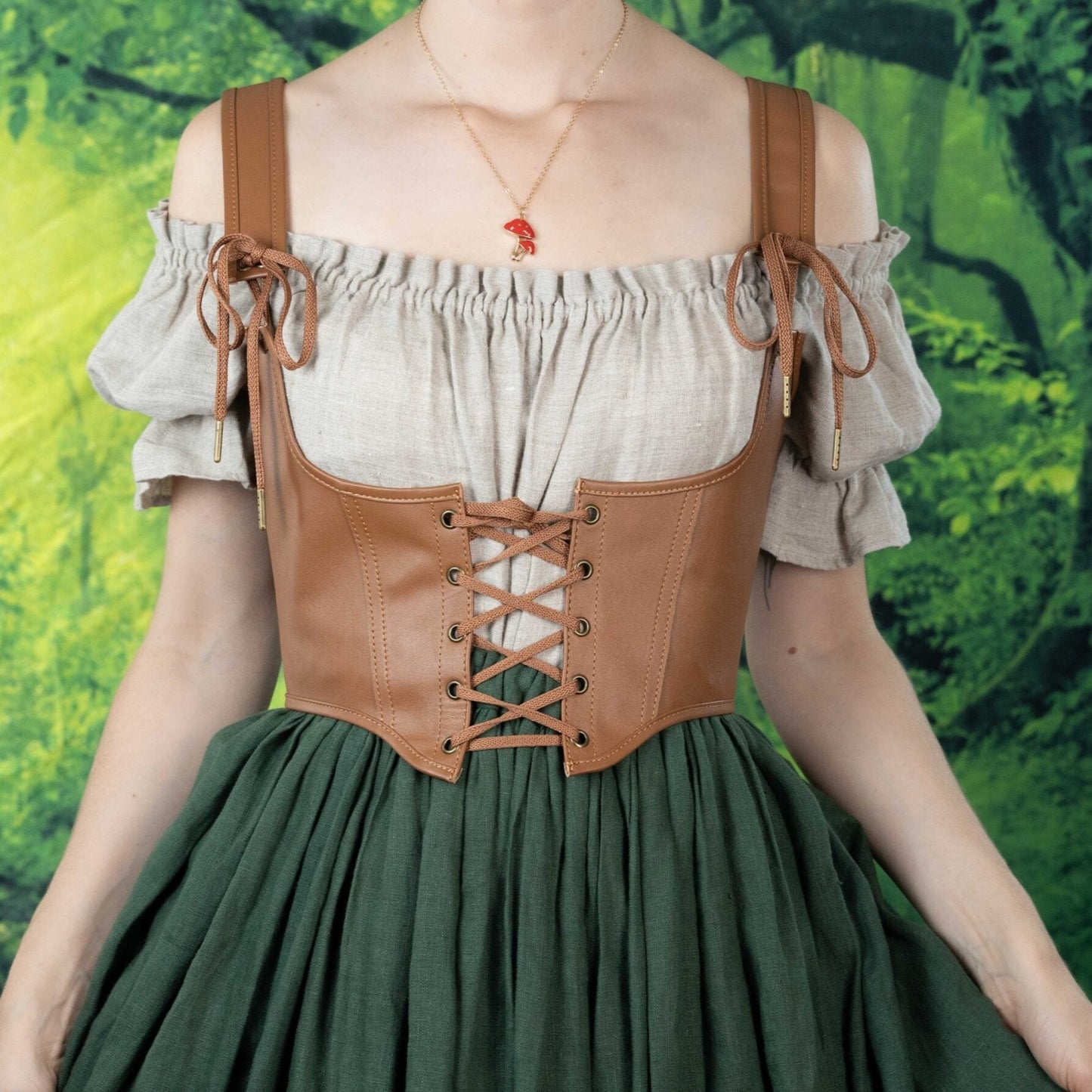 Leather underbust corset belt with lace-up front worn over off-shoulder peasant blouse and green skirt in renaissance style