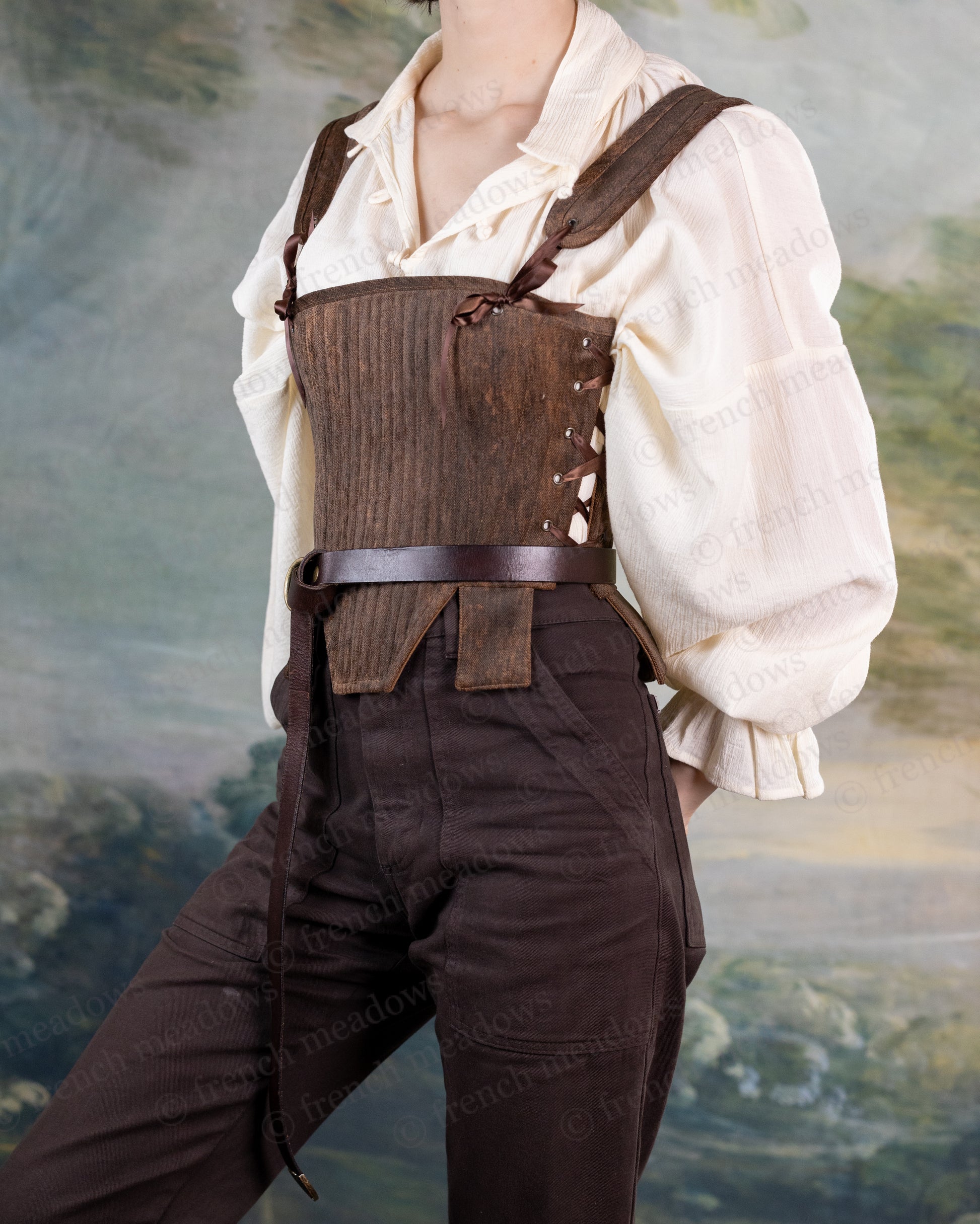 Brown Tabbed Tudor Stays shown with cream blouse, featuring side lacing, decorative waist tabs, and structured boning details