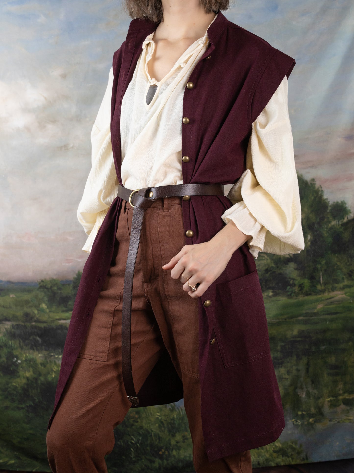 Burgundy Pirate Vest in rich linen worn over cream shirt with leather belt, styled for historical costumes.