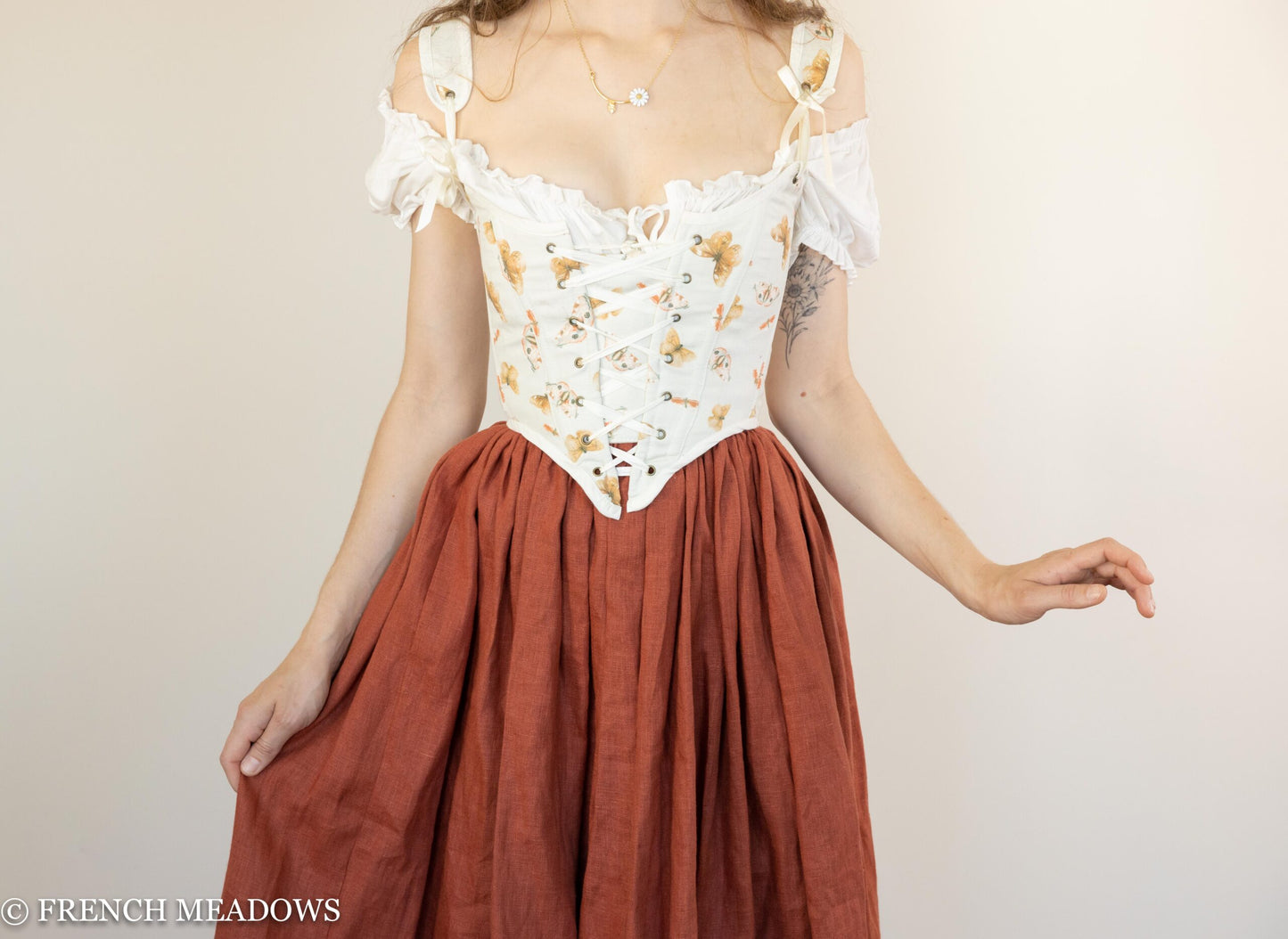 Handmade butterfly linen renaissance bodice with ivory corset top and rust-colored gathered skirt shown on model