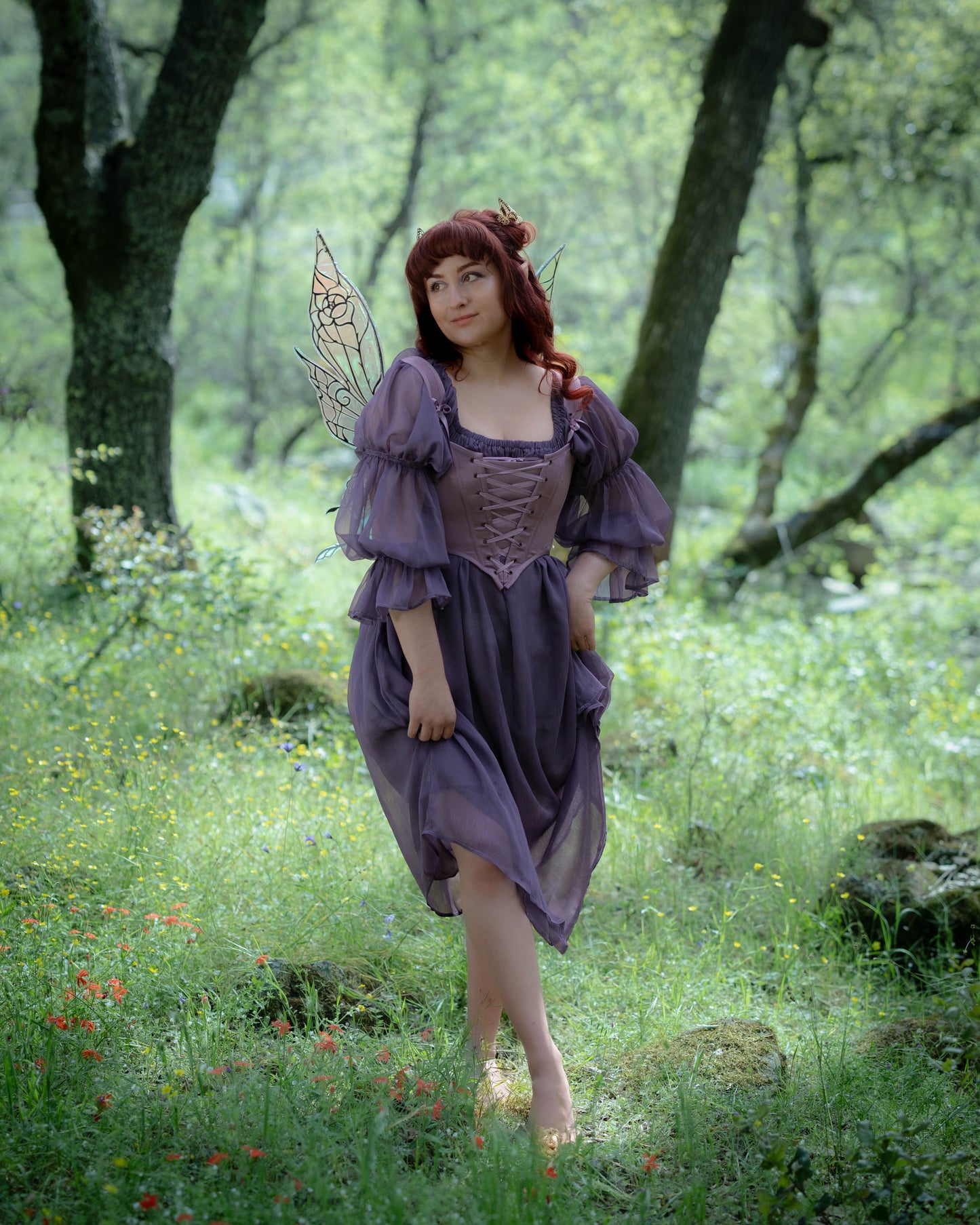Model wearing Purple Dusk Satin Corset Top with adjustable lacing and removable straps in a forest setting.
