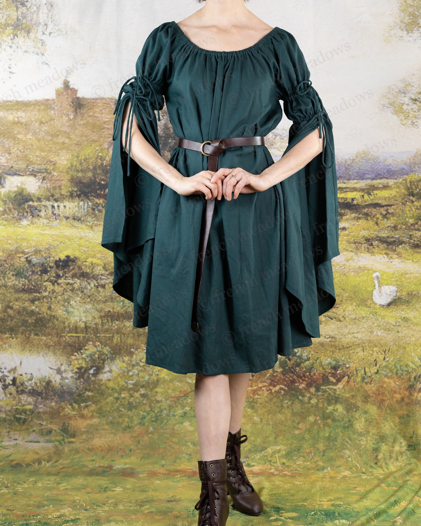 Dark green linen bell sleeve chemise dress with flowing medieval-style sleeves and elastic neckline, belted at waist