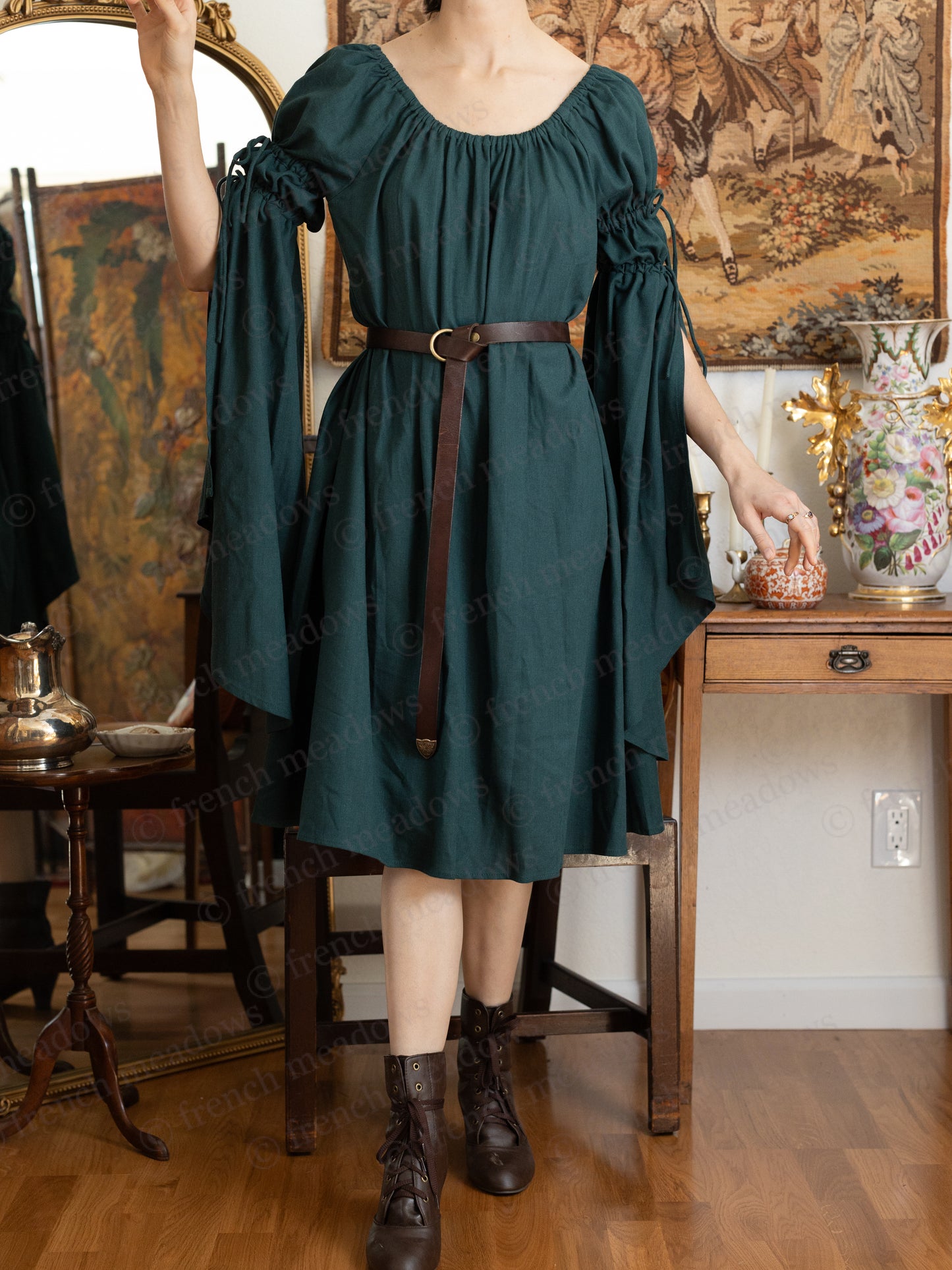 Dark green linen bell sleeve chemise dress with brown leather belt, shown in medieval-inspired style with flowing sleeves