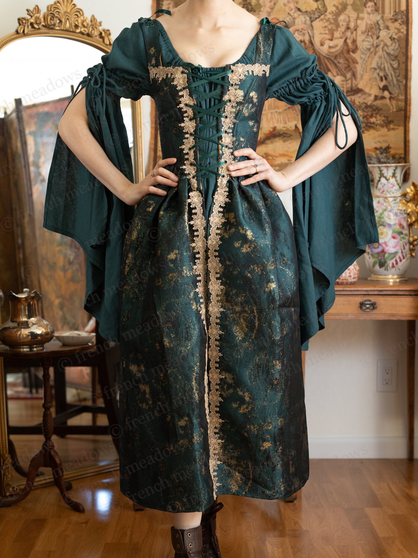 Dark green linen bell sleeve chemise with flared medieval-style sleeves and elastic neckline shown on mannequin against vintage decor