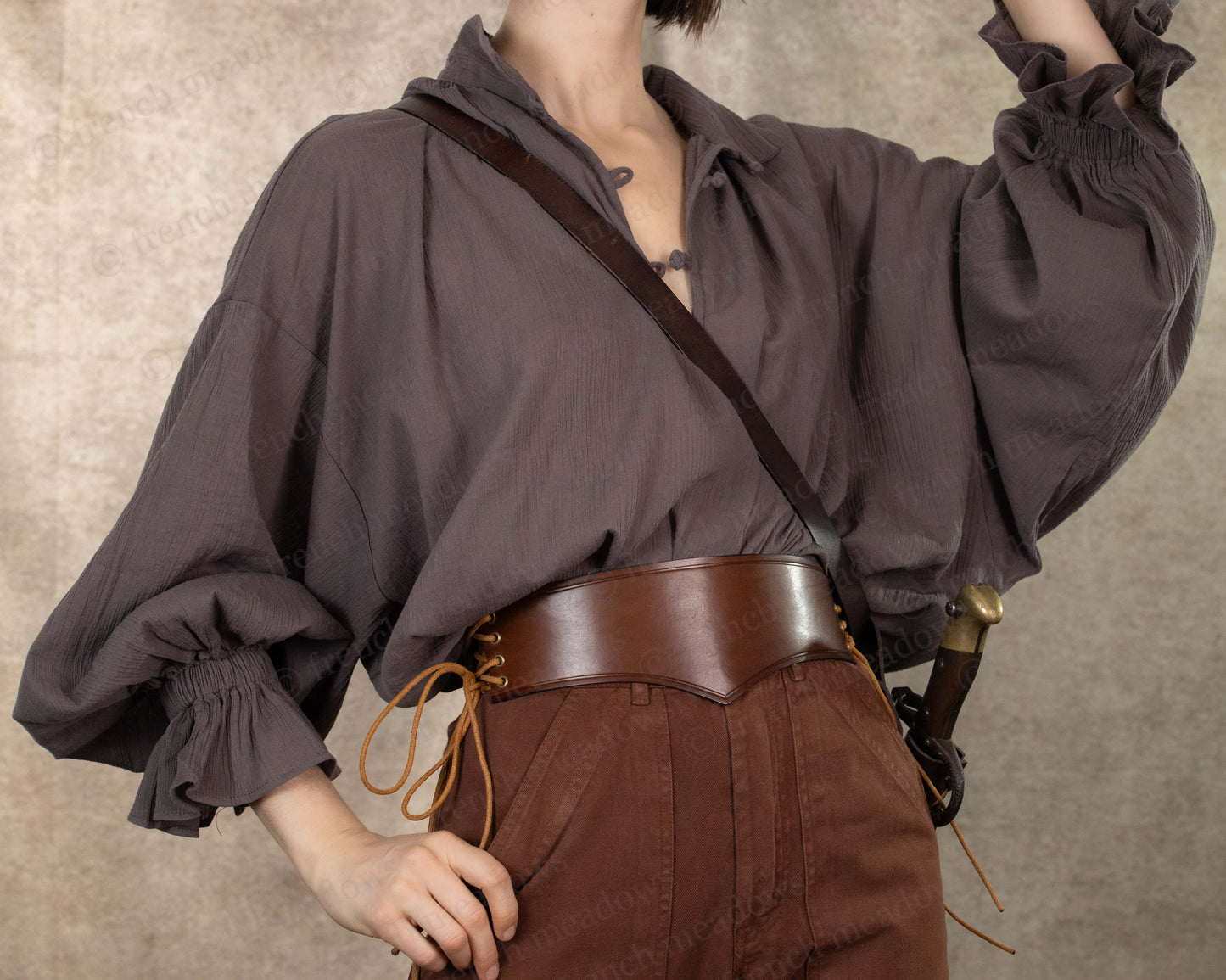 Darcy Shirt in charcoal grey with billowing poet sleeves and knotted neckline worn with brown leather belt and trousers
