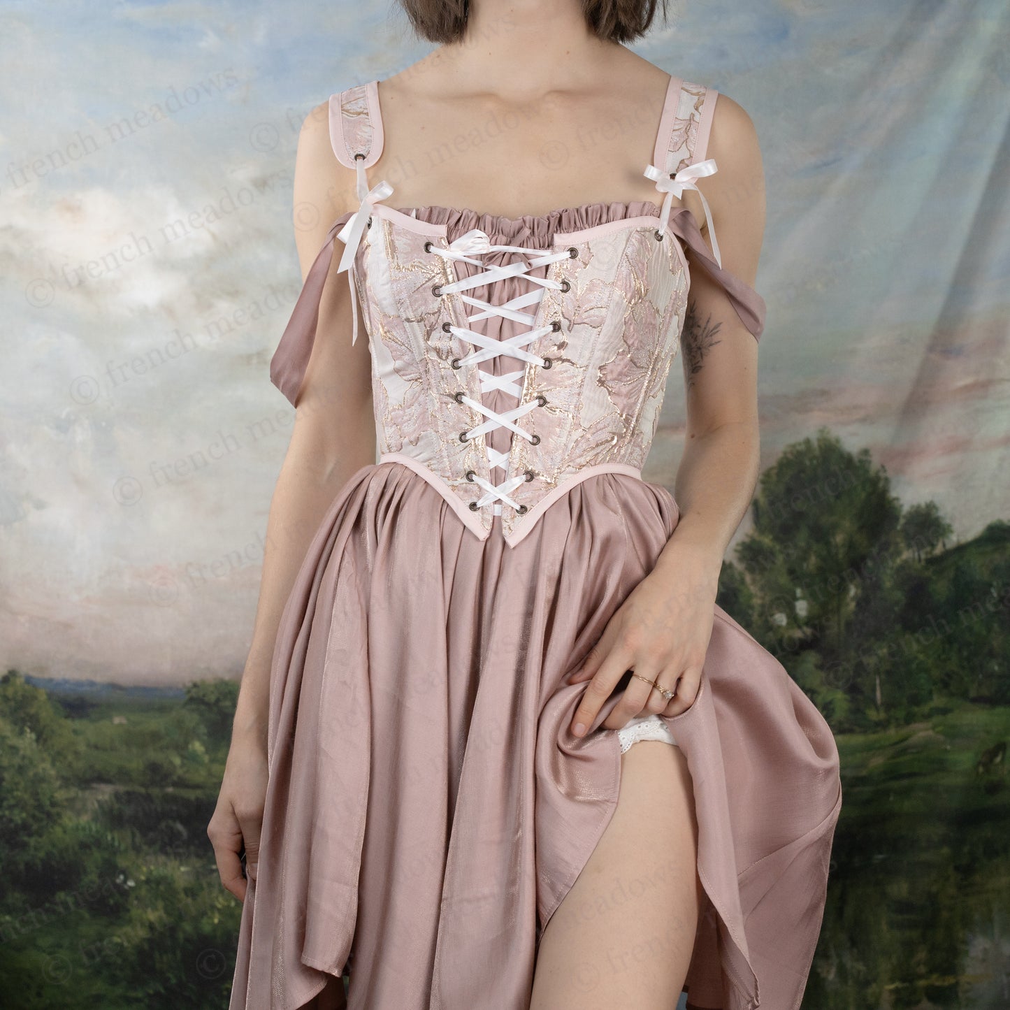 Woman wearing a romantic Flutter Fairy Dress with adjustable straps and a handkerchief hem styled as a skirt.