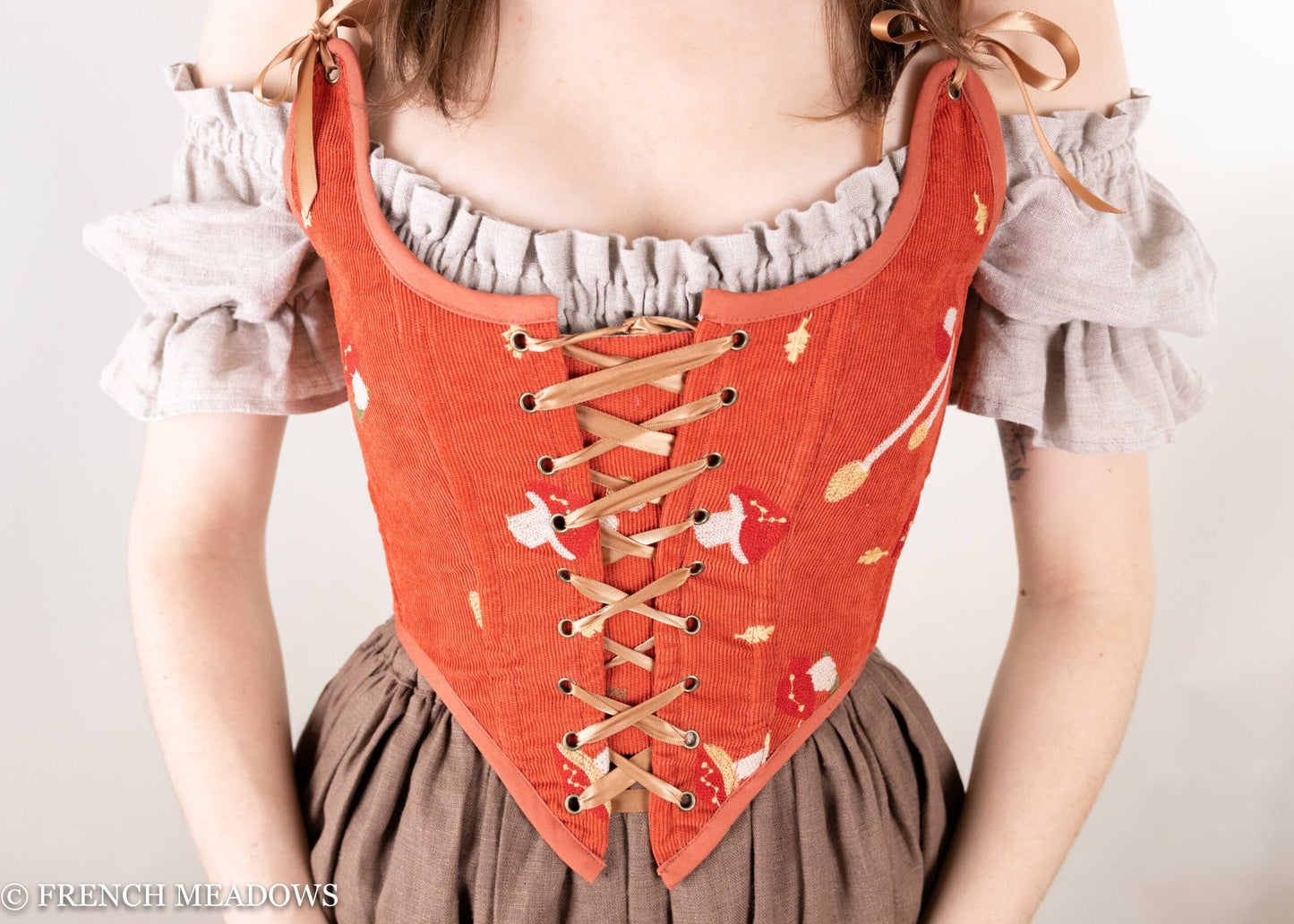 Handmade Renaissance bodice in burnt orange corduroy with embroidered mushrooms, lace-up front and ruffled off-shoulder sleeves