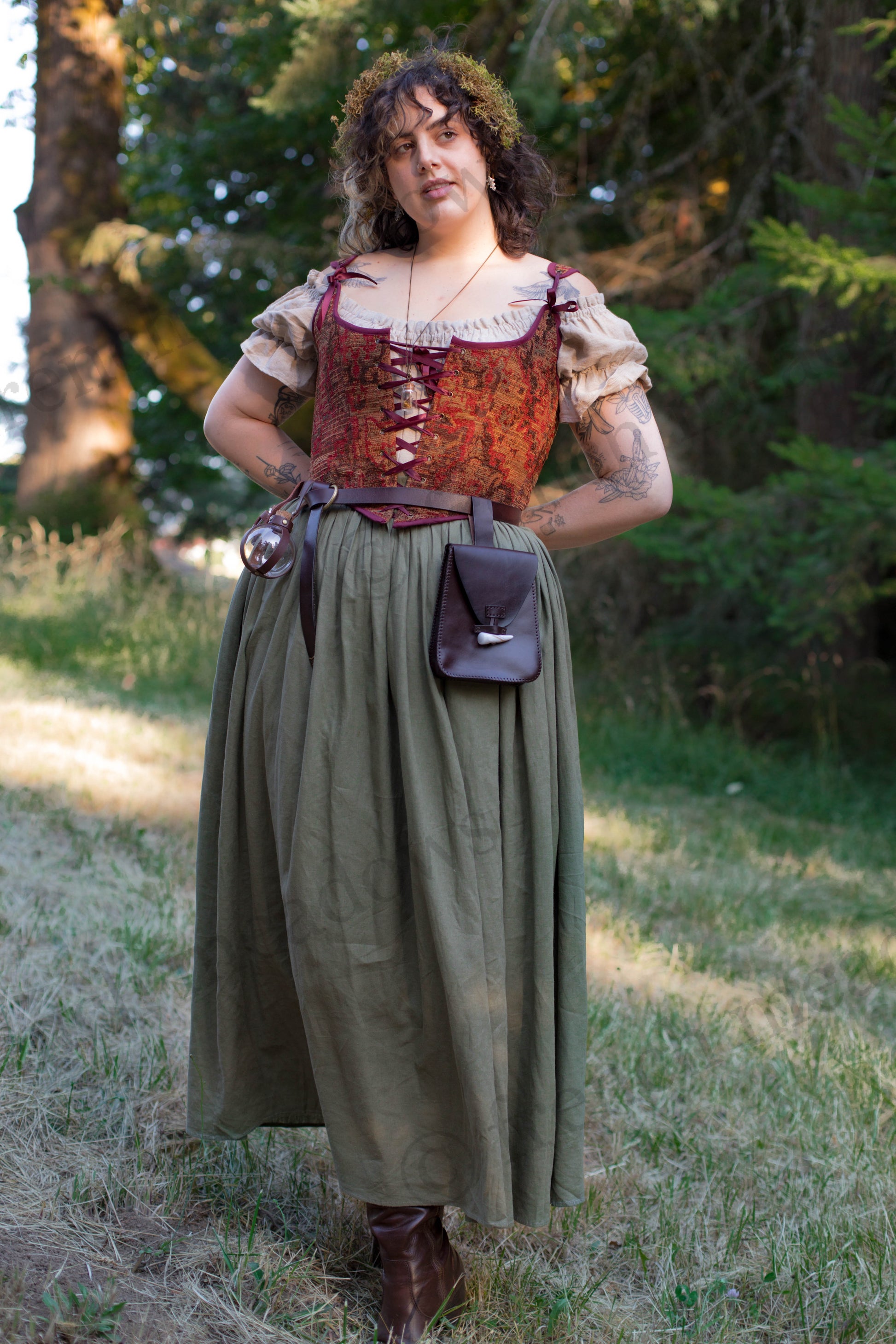 Leather Belt Pouch shown on medieval costume with brown leather, horn toggle closure against forest backdrop