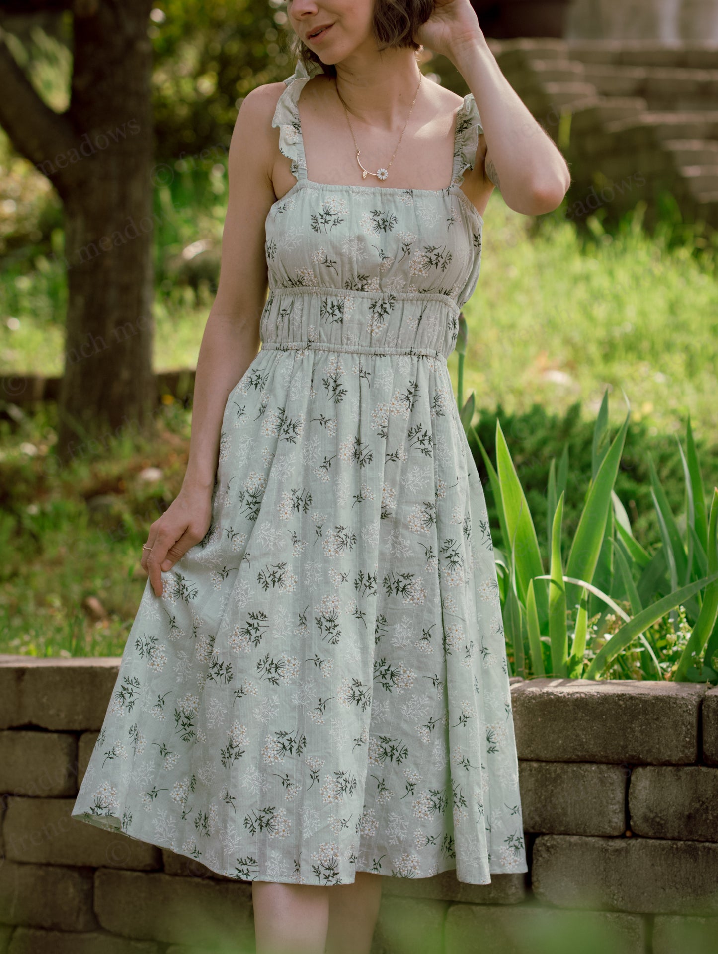 Floral Milkmaid Dress featuring a ruched bodice, square neckline, A-line skirt, and floral cotton fabric with pockets.