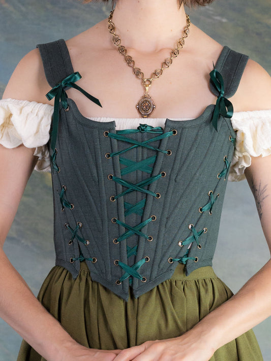 Woman wearing a Medieval Pendant Necklace with vintage-style dress featuring lace-up bodice and puff sleeves against painted backdrop