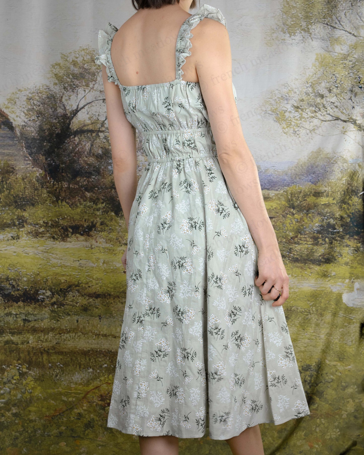 Floral Milkmaid Dress featuring a ruched bodice, square neckline, elastic waist, A-line skirt, and floral cotton fabric.