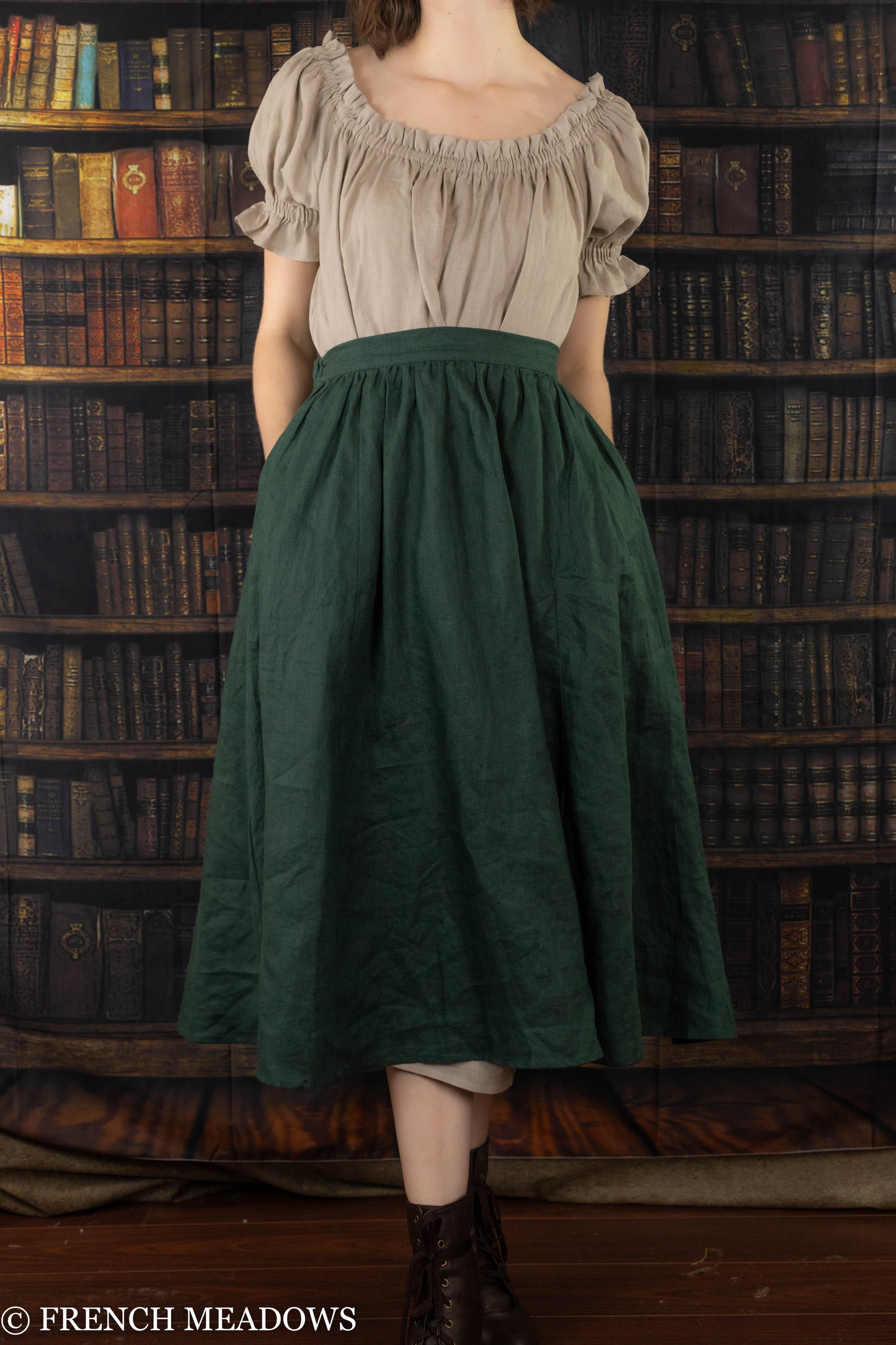 Evergreen Green Linen Midi Skirt paired with peasant blouse shown against vintage library backdrop with dark wooden floors