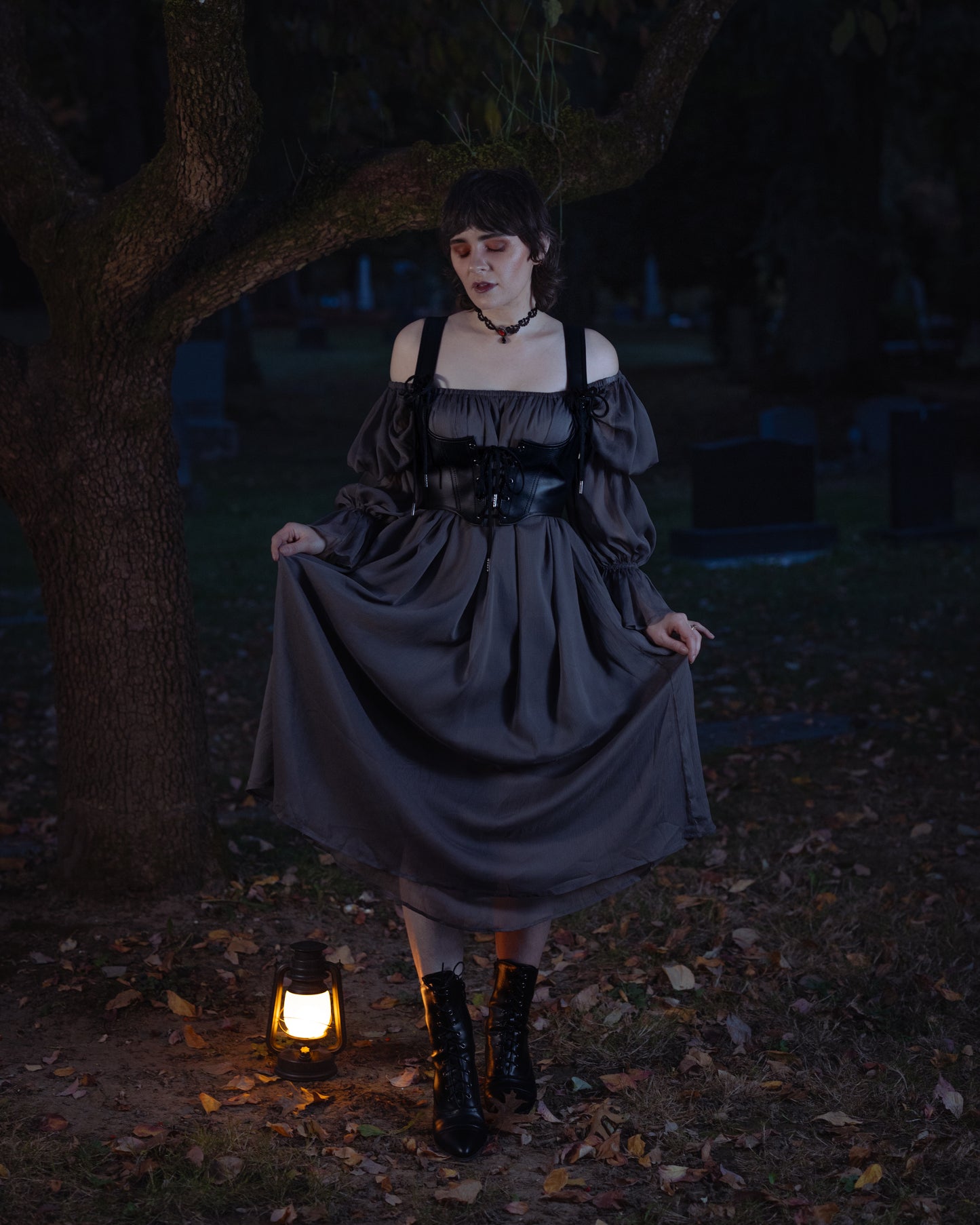 Grey Chiffon Chemise shown outdoors at dusk with lantern light, flowing medieval-style dress with puff sleeves and square neckline