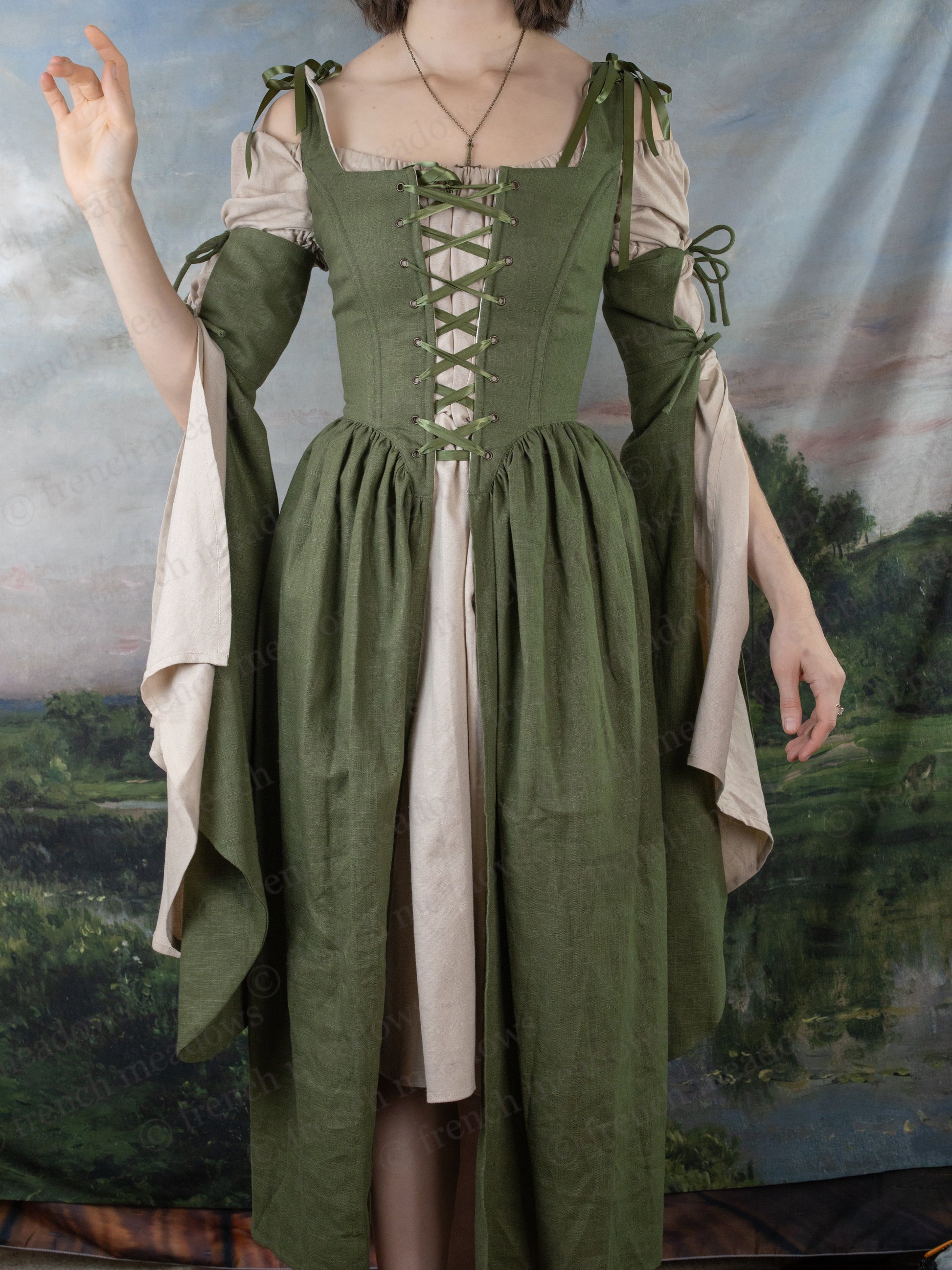 Ivy Green Corset Dress with medieval-style lacing, flowing bell sleeves and adjustable straps in forest-inspired design
