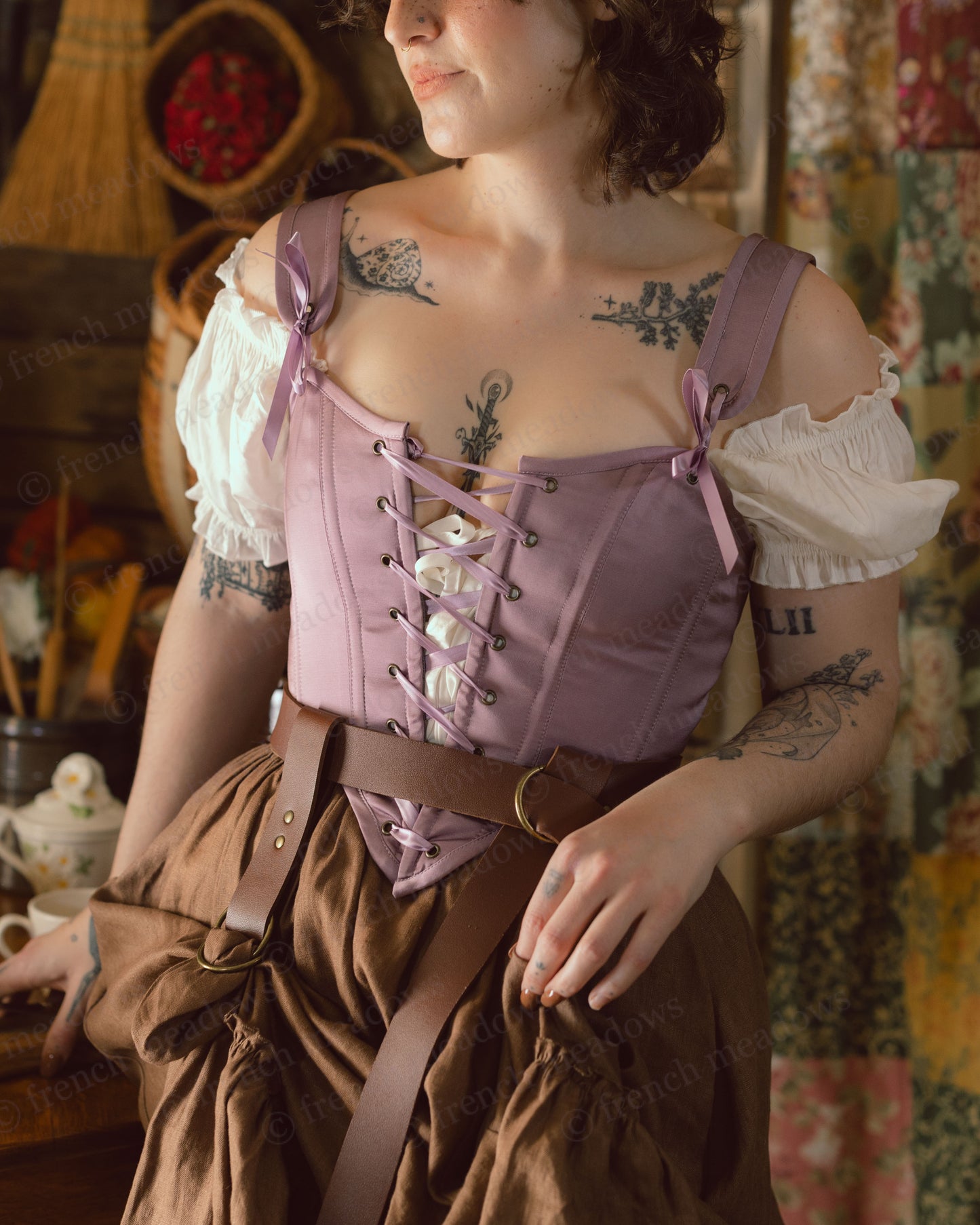 Purple Dusk Satin Corset Top with adjustable lacing and white puffy sleeves, paired with brown belted skirt in vintage setting