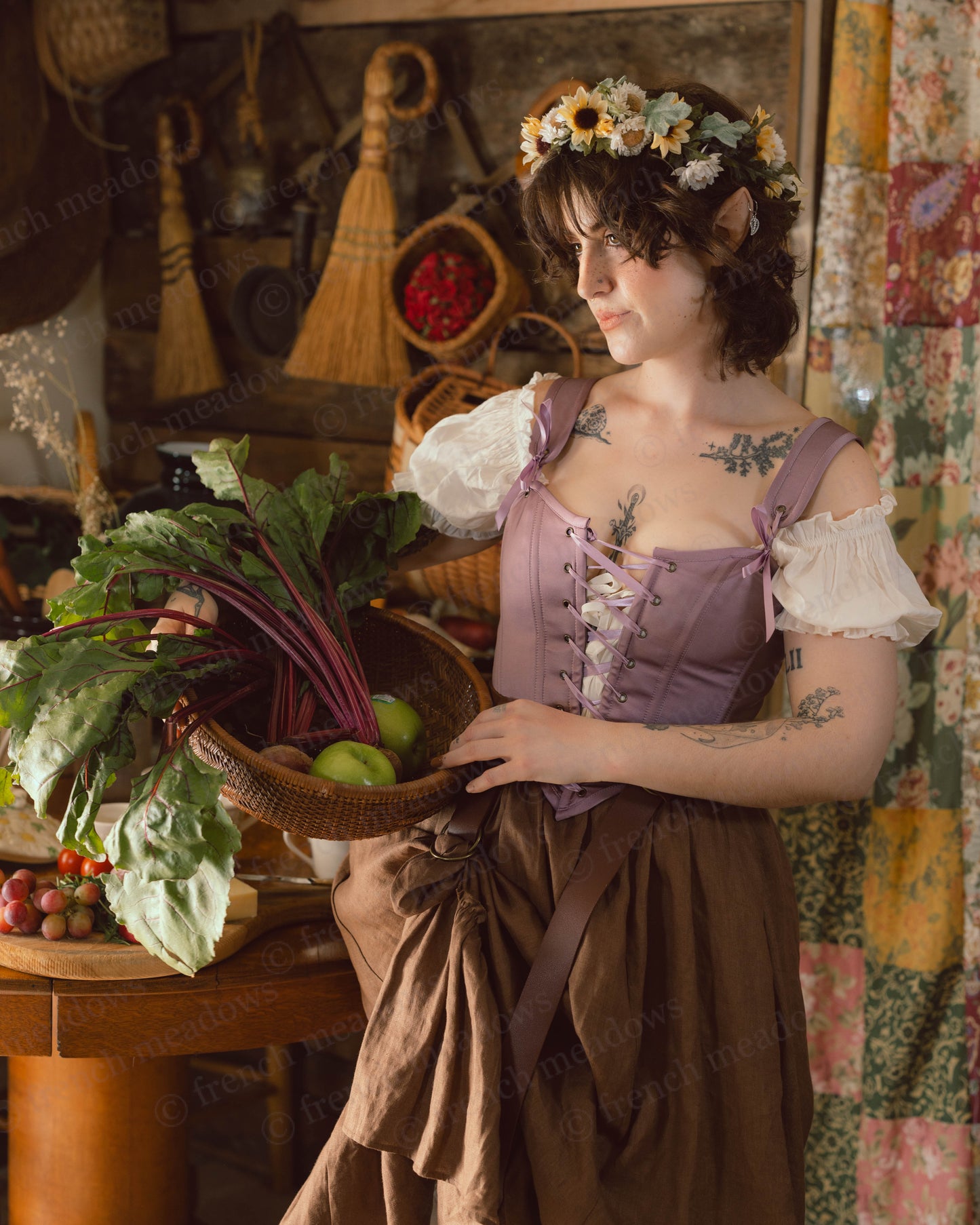 Purple Dusk Satin Corset Top styled in cottagecore setting with floral crown and rustic vegetables in woven basket