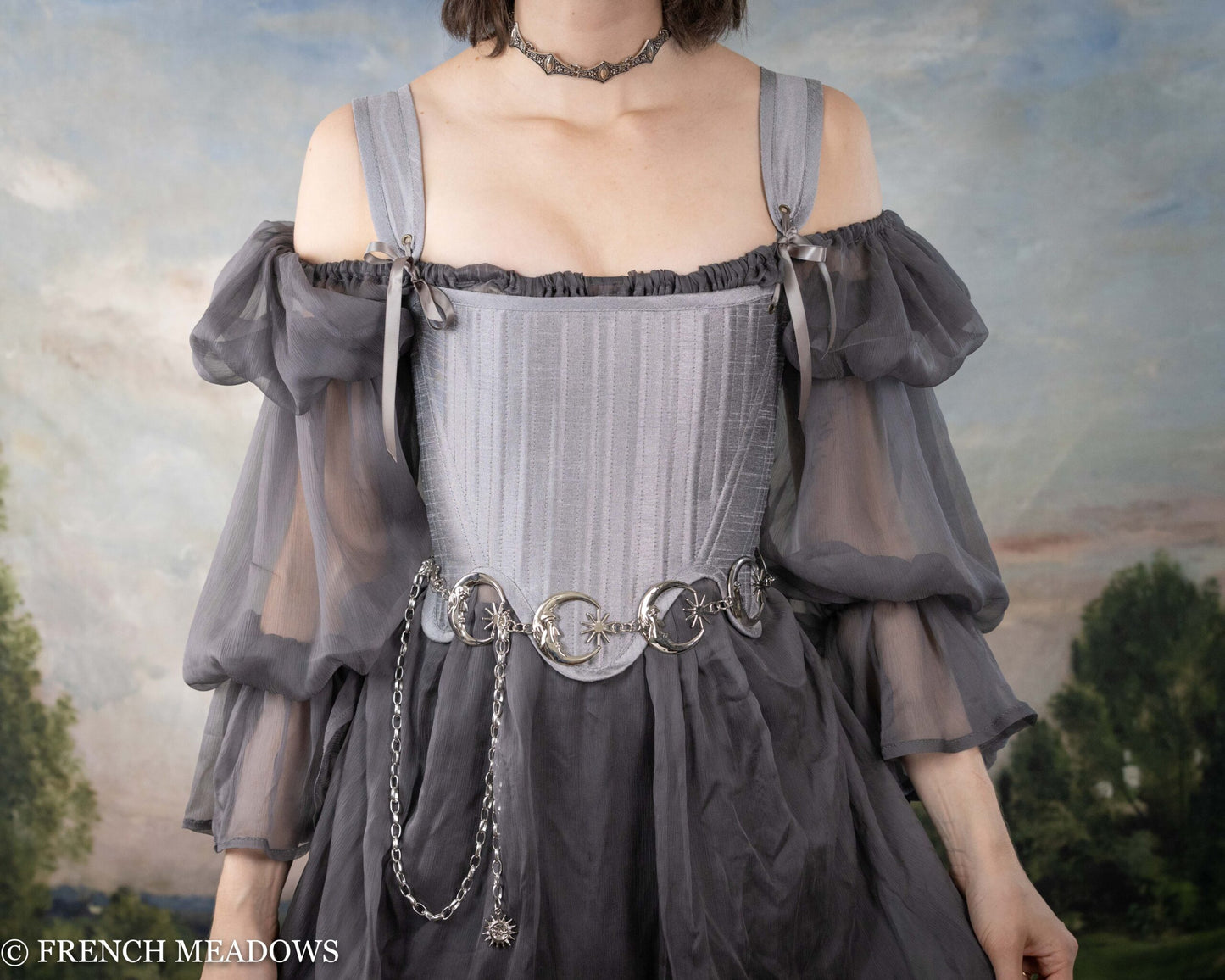 Grey Chiffon Chemise with off-shoulder puff sleeves and delicate chain belt detail, shown against pastoral background
