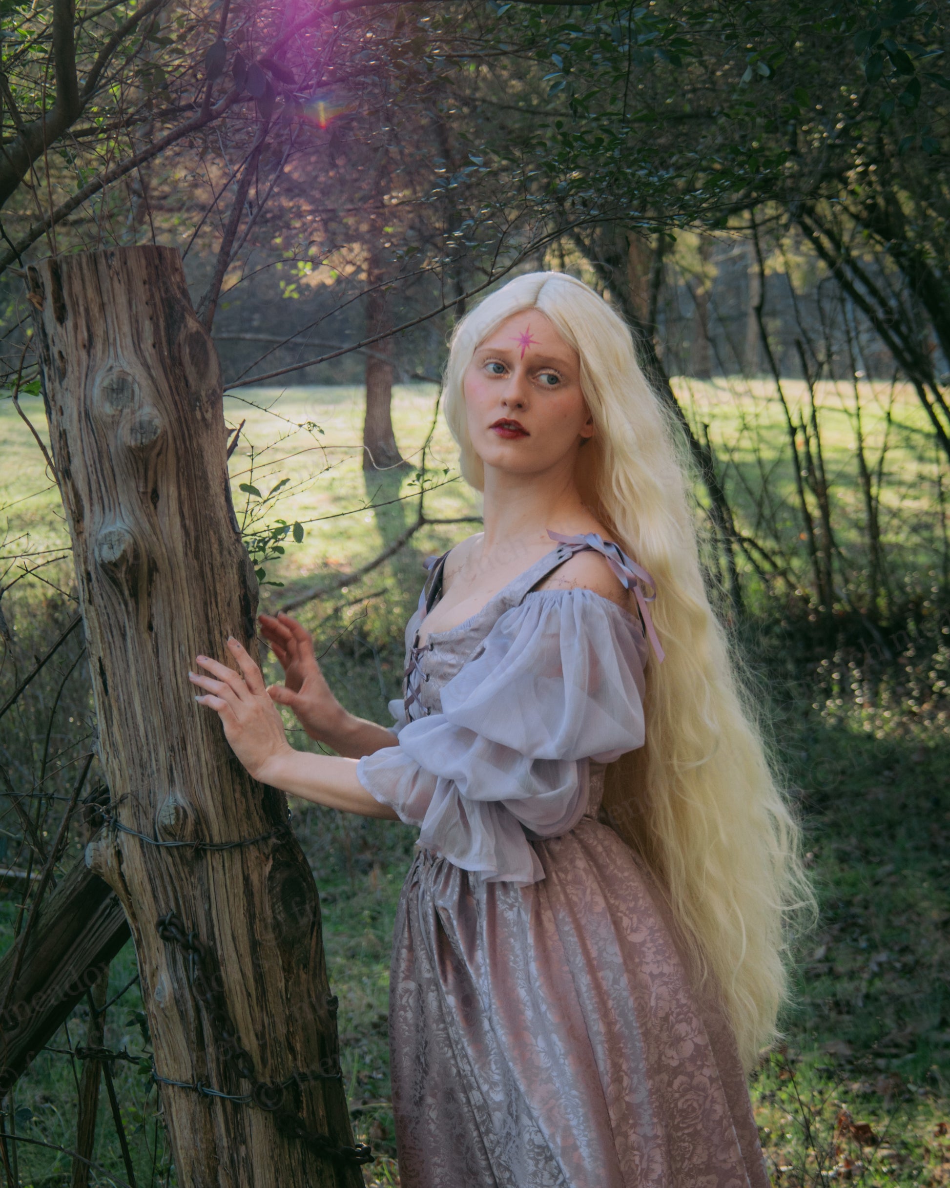 Lavender Floral Satin Corset Dress shown in enchanted forest setting with sunlit trees and magical atmosphere