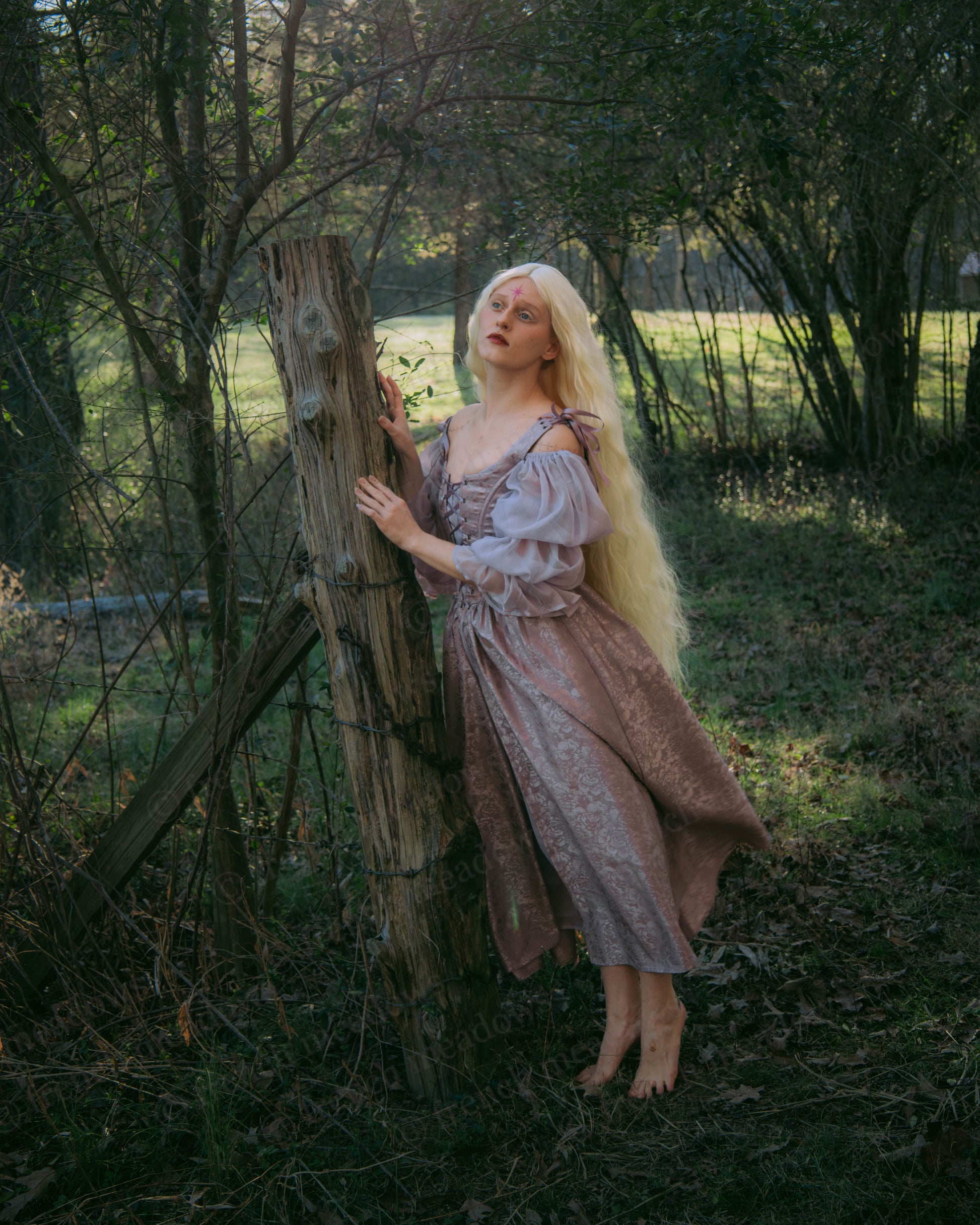 Lavender Floral Satin Corset Dress shown in enchanted forest setting, highlighting shimmering purple fabric and romantic corset design