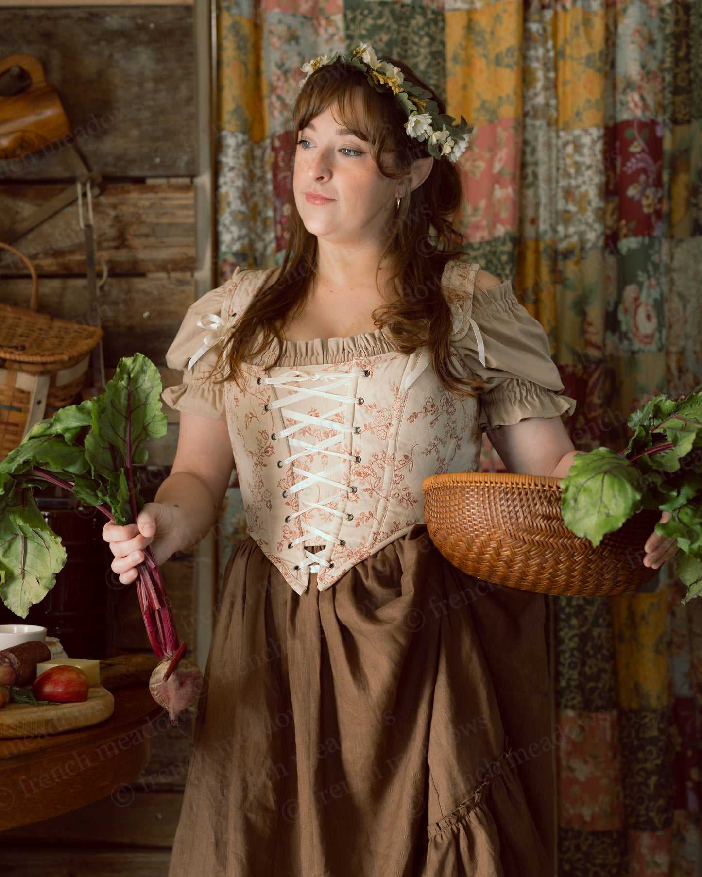 Rosey Ivory Floral Corset Top shown in cottage core setting with flower crown, brown skirt and woven basket